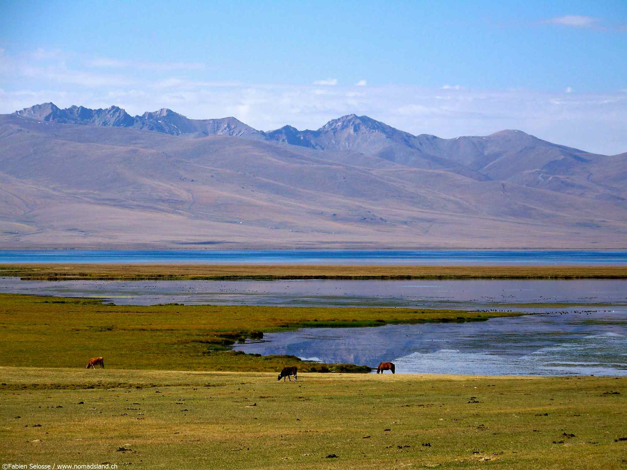 View of Song Kul Lake with mountains in the background, Kyrgyzstan.