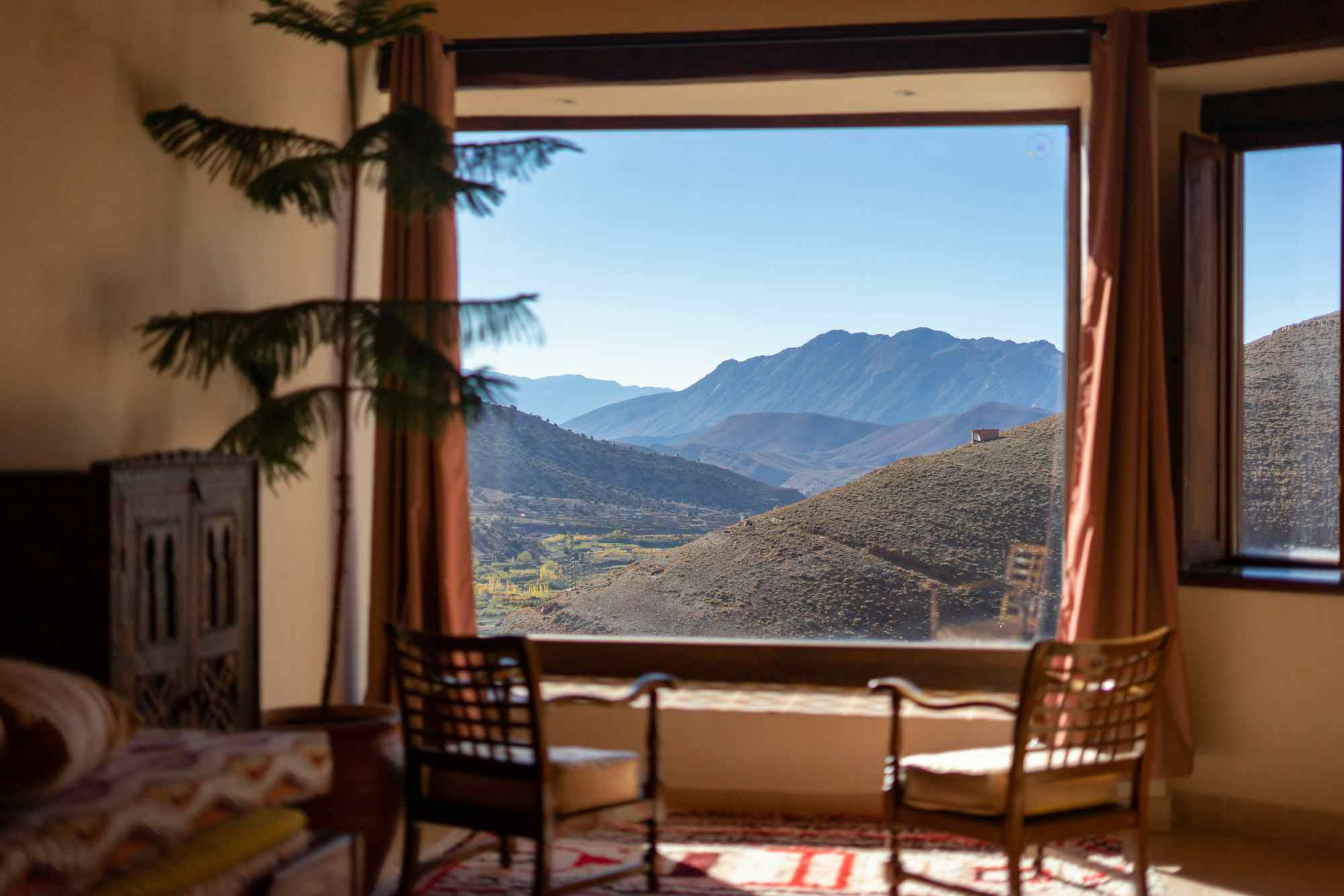 2 chairs in front of a window overlooking beautiful mountain scenery in Morocco