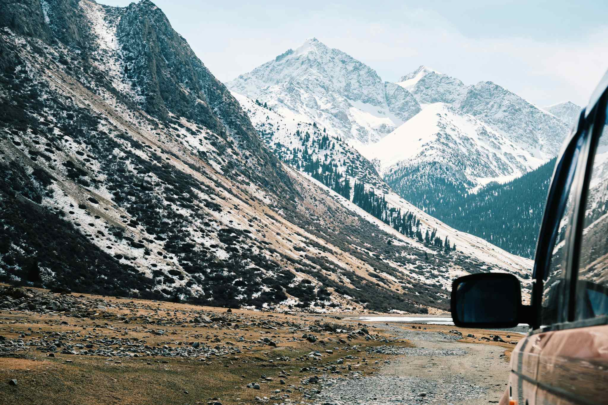 A 4WD vehicle heading into the snowy Tian Shan Mountains