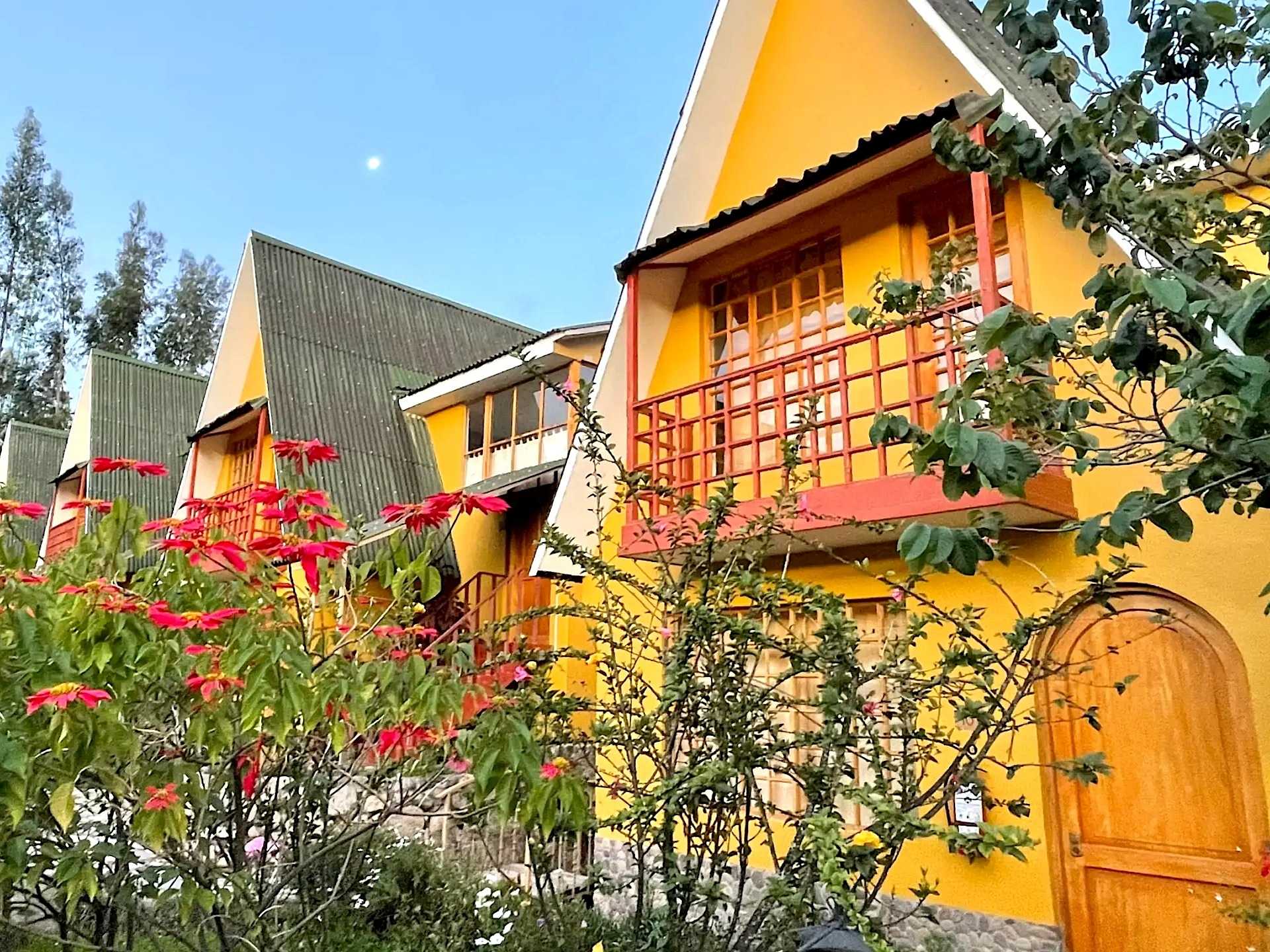 Bright yellow cabins with wooden doors and front balcony