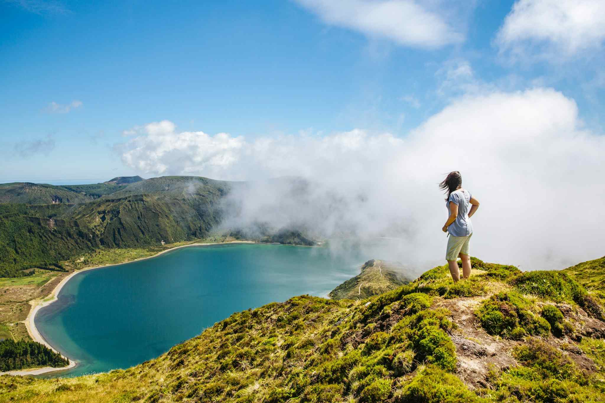 Hiker overlooking Lago do Fogo on Sao Miguel Island, Azores