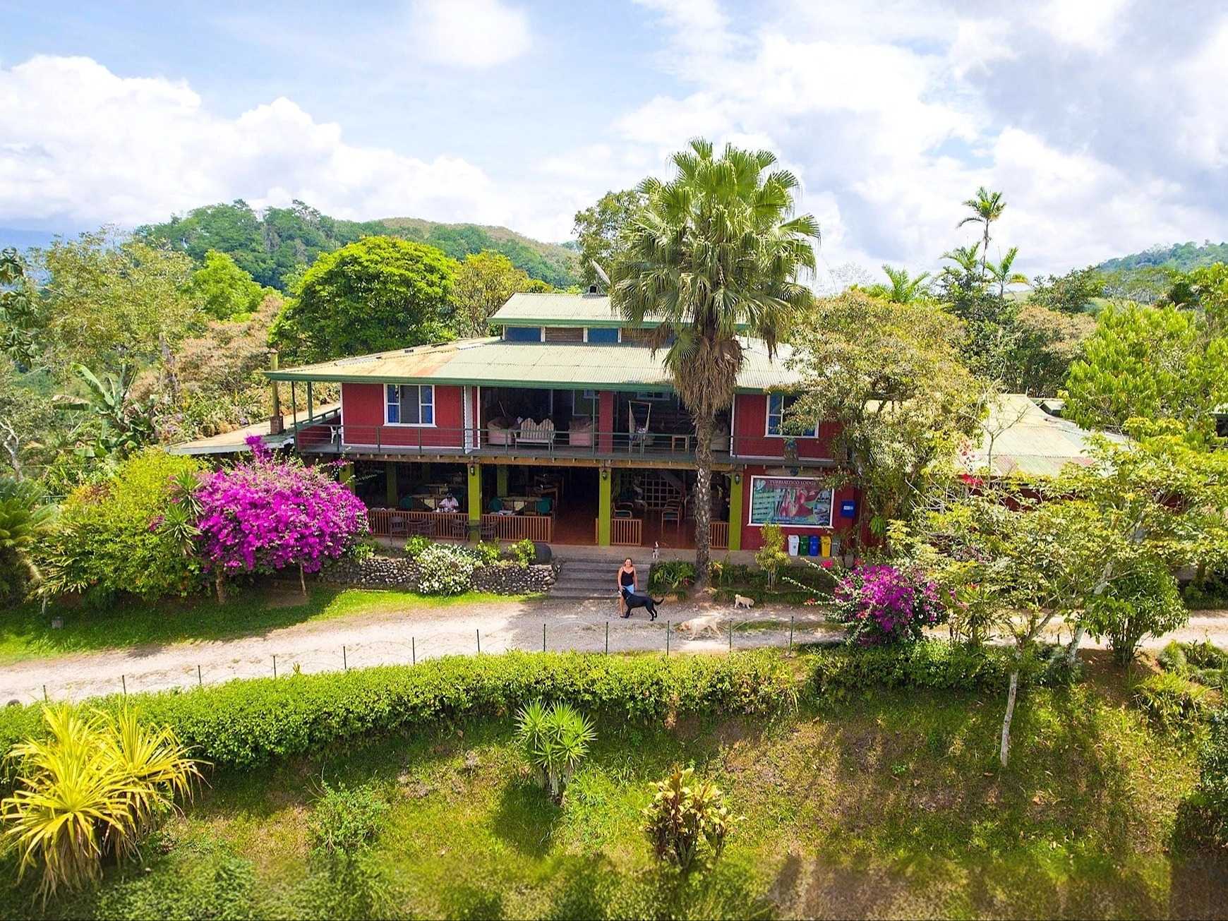 Large guesthouse painted in red perched in the valley of Turrialba