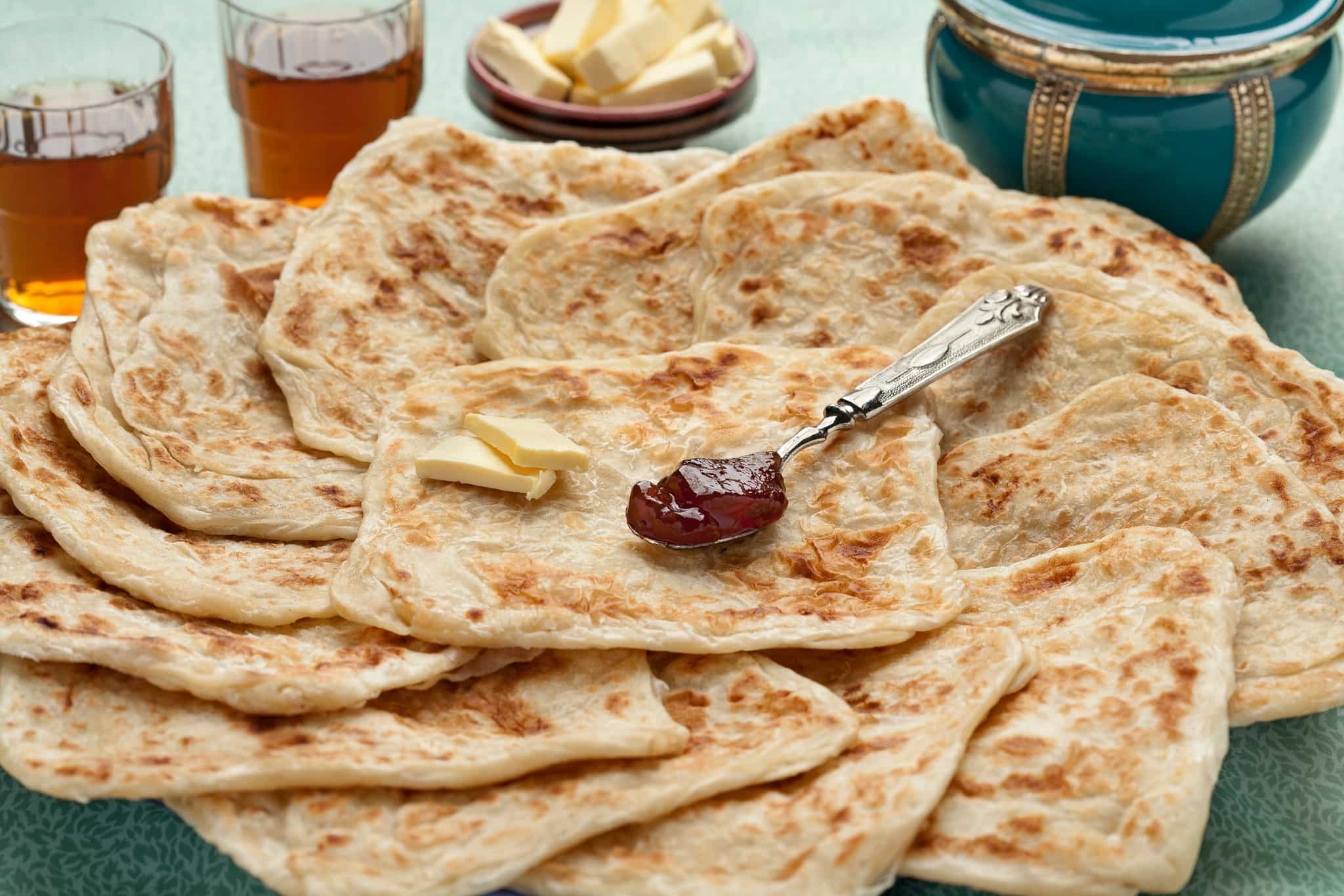 Fresh baked Moroccan square pancakes called Rghaif or Msemen with butter and jam