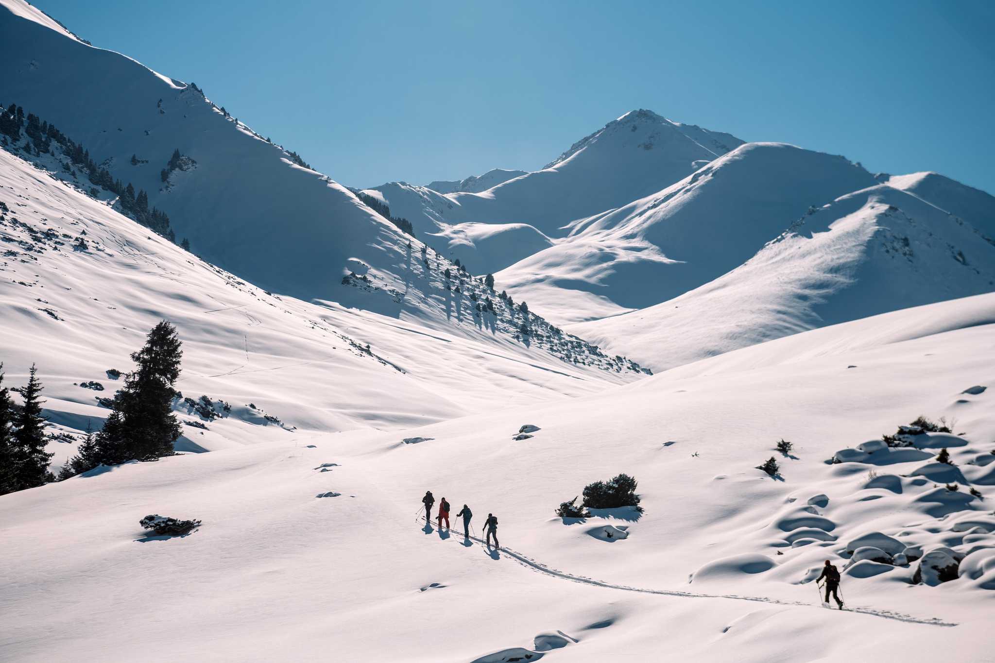 A group snowshoeing into the remote mountains of Kyrgyzstan