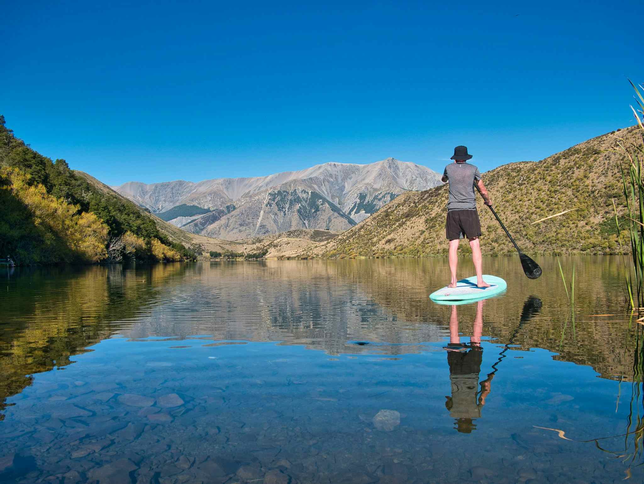 Paddleboarder in the New Zealand wilds