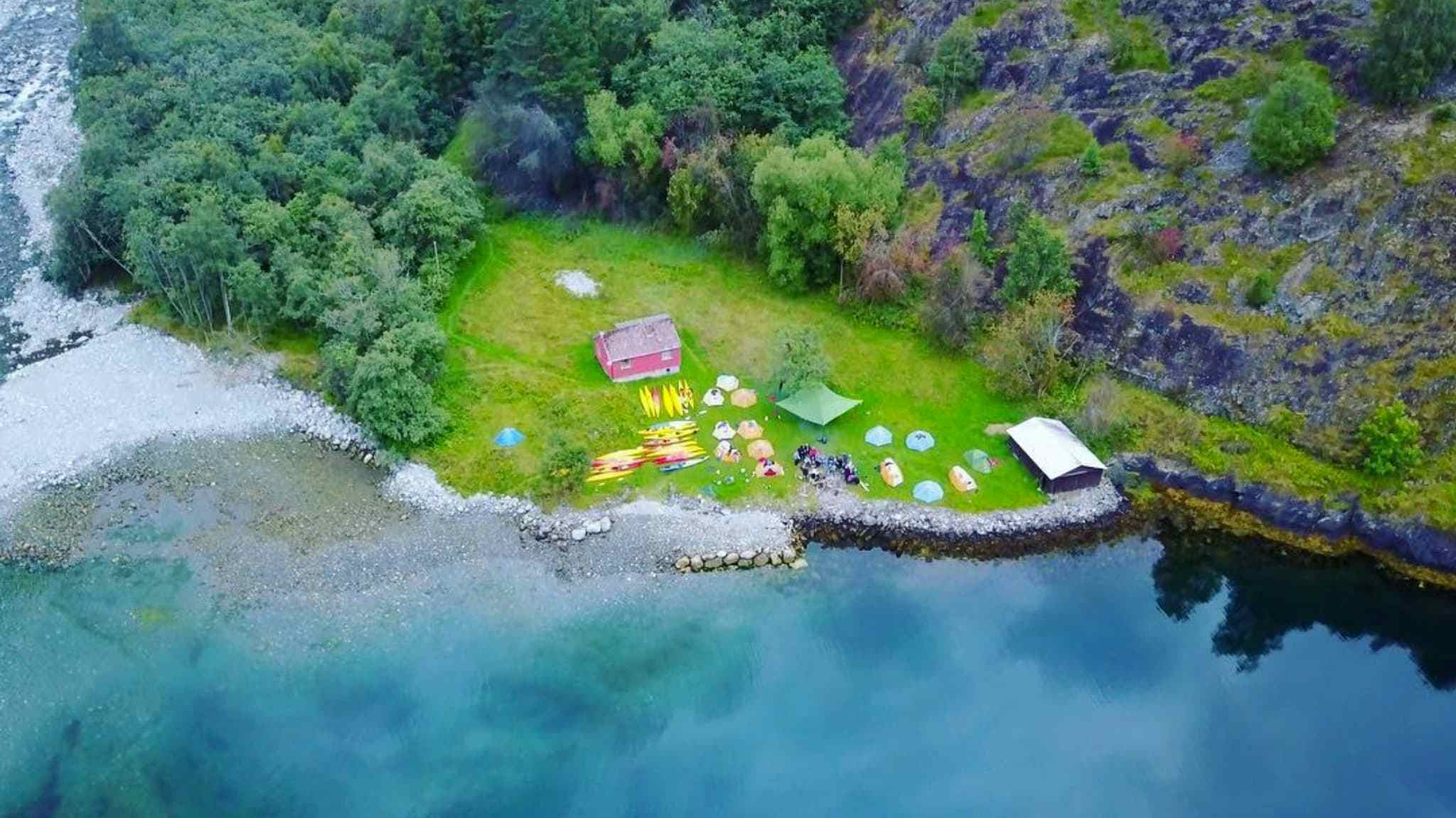 Aerial shot of camp at fjords edge. 