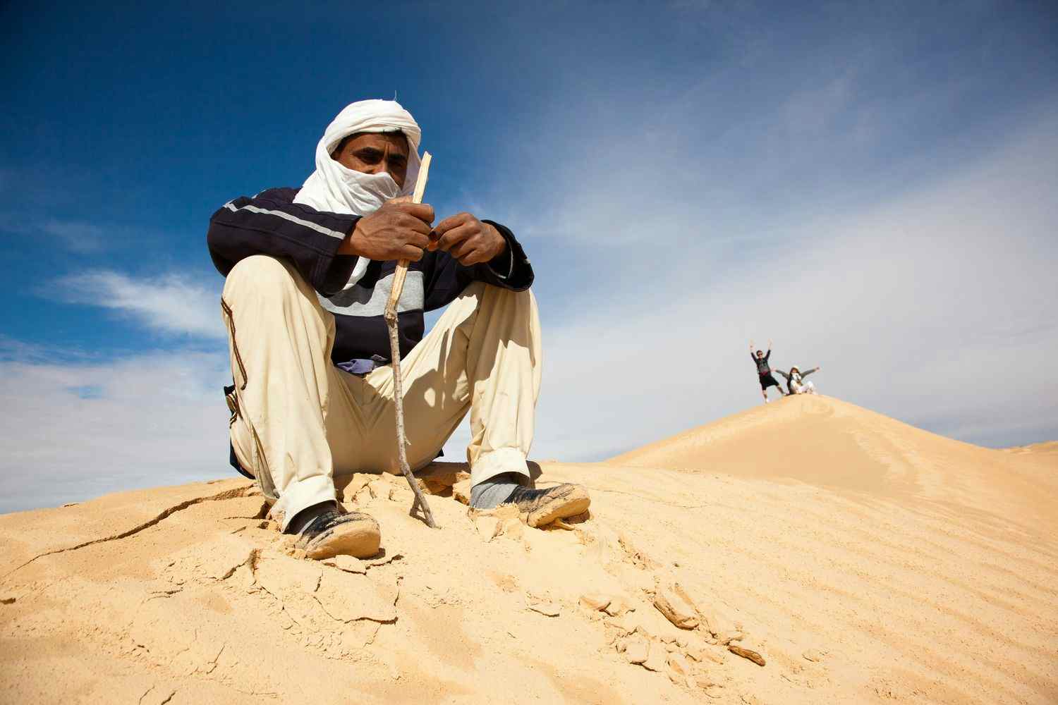 Camel driver in Tunisia's Sahara Desert
