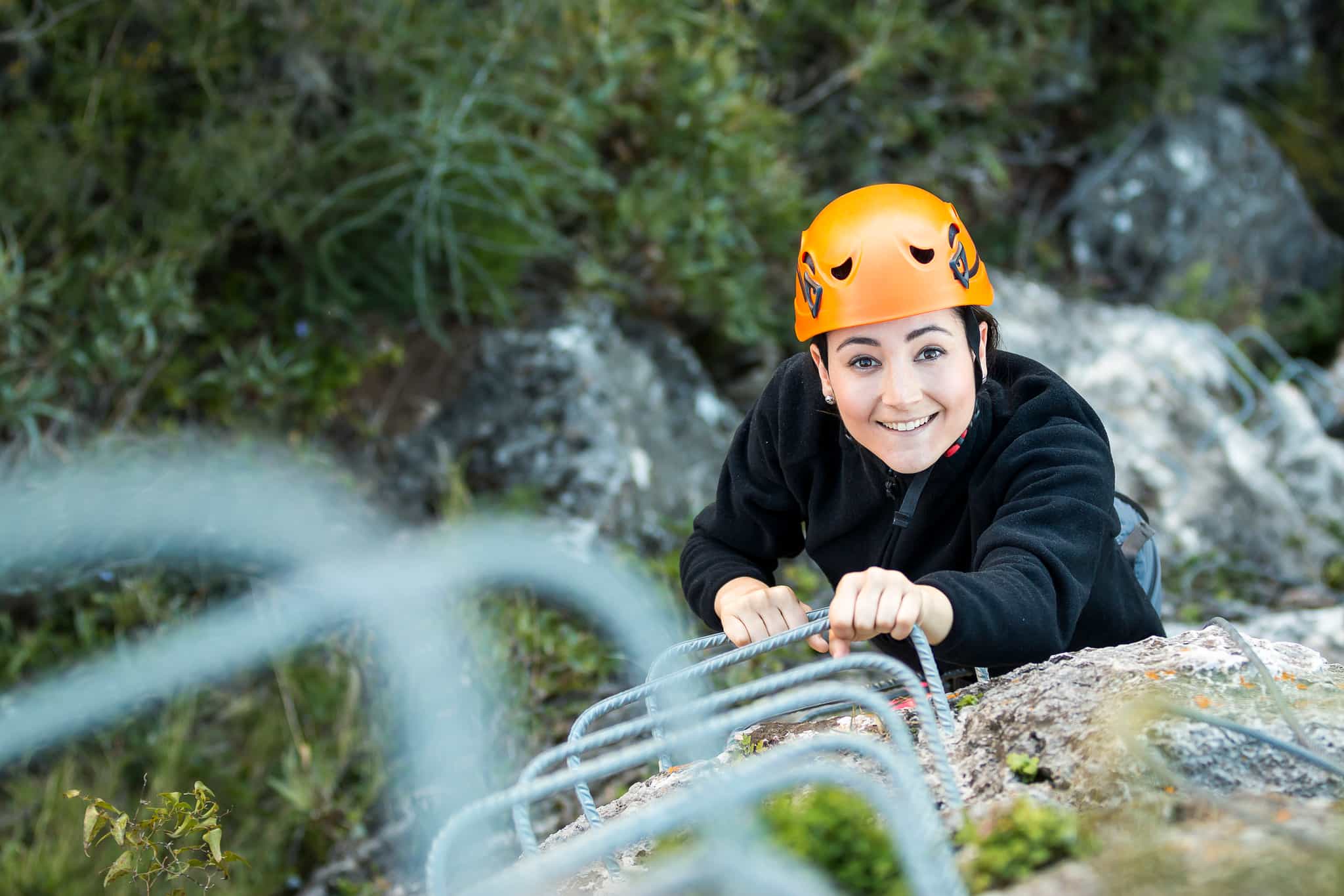 A woman climbing up the Via Ferrata