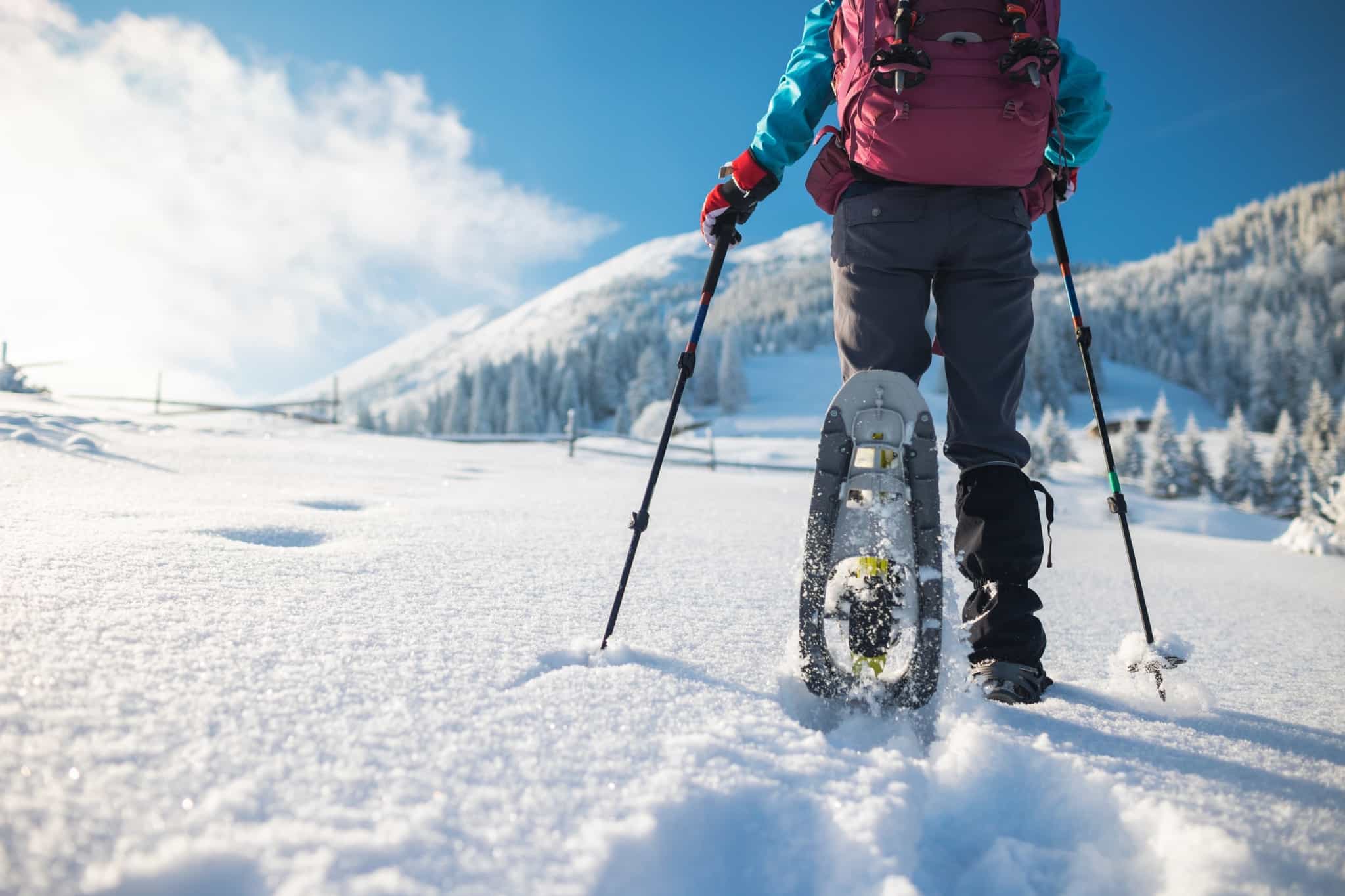 Women making her way through the snow on snowshoes