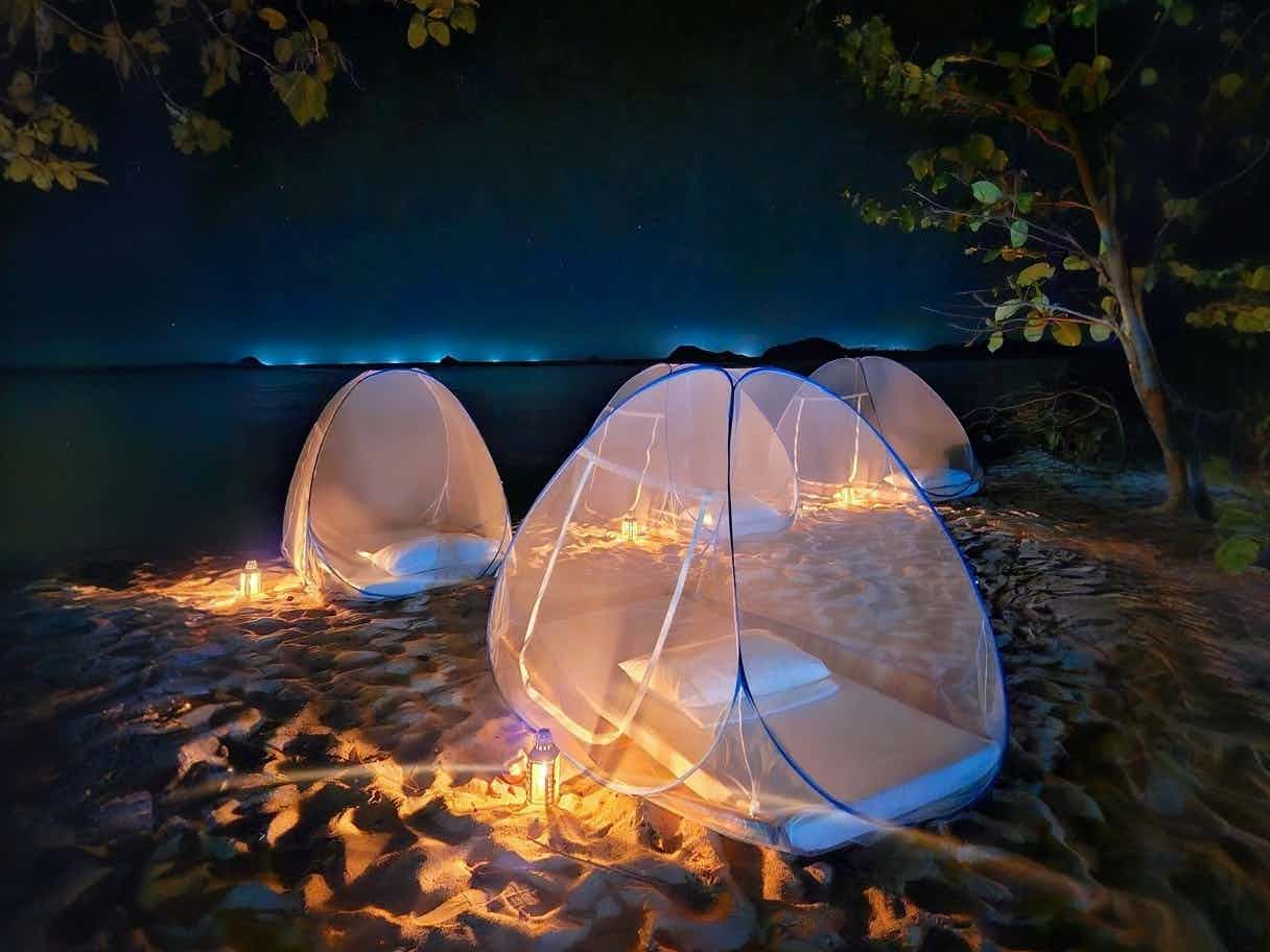 Mesh tents on the beach at night in the Philippines.