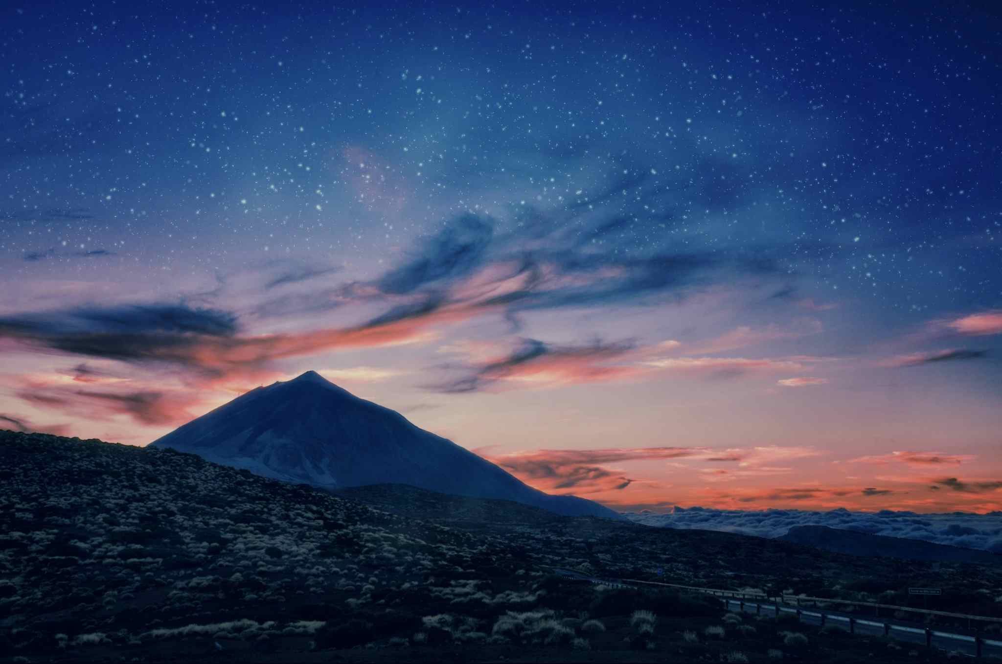 Silhouette of volcano del Teide against a sunset sky 