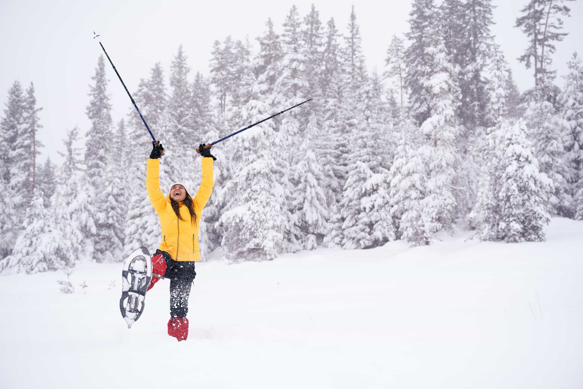 Showshoer celebrates in the forest