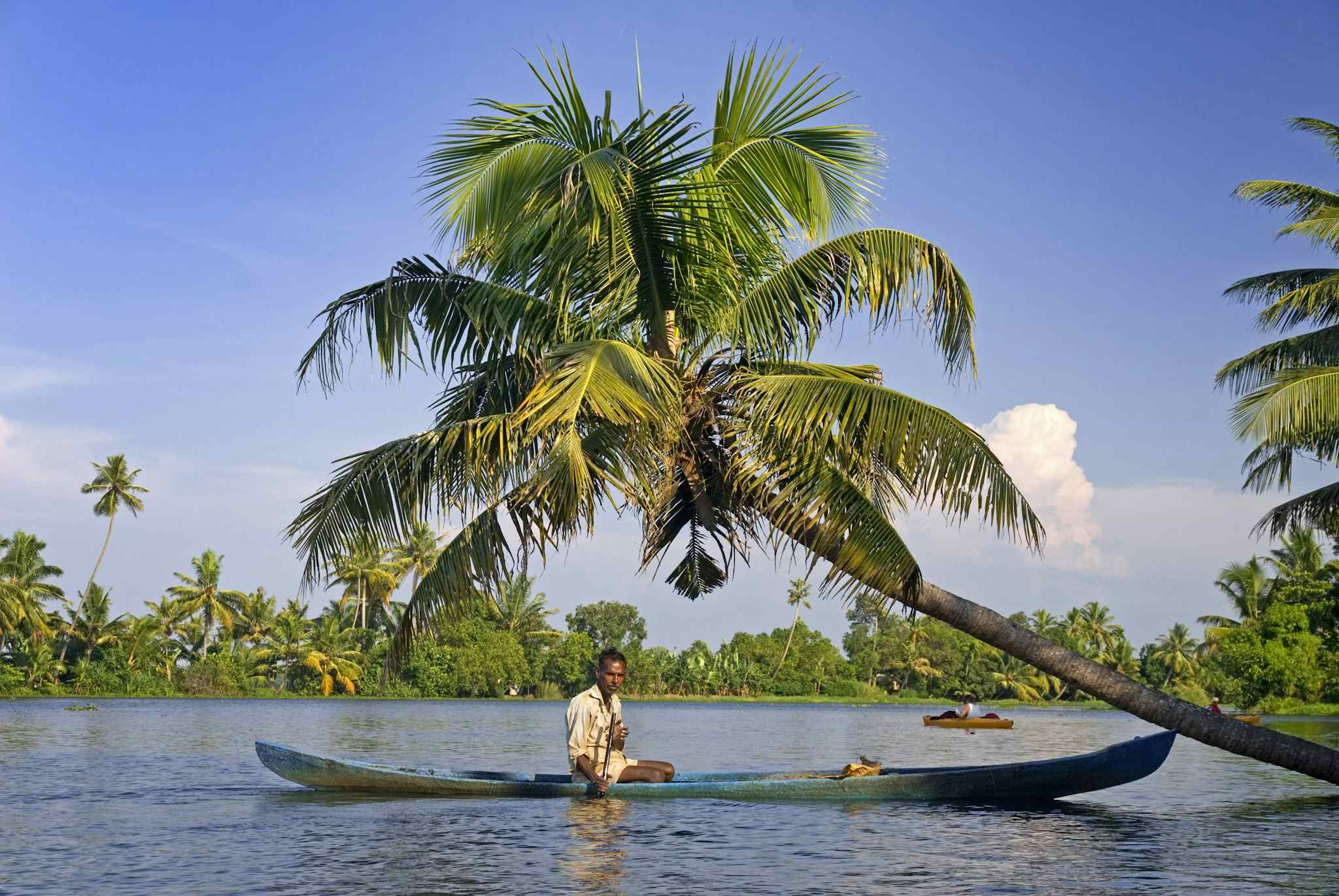 Local on a traditional canoe in the Keralan Backwaters, India