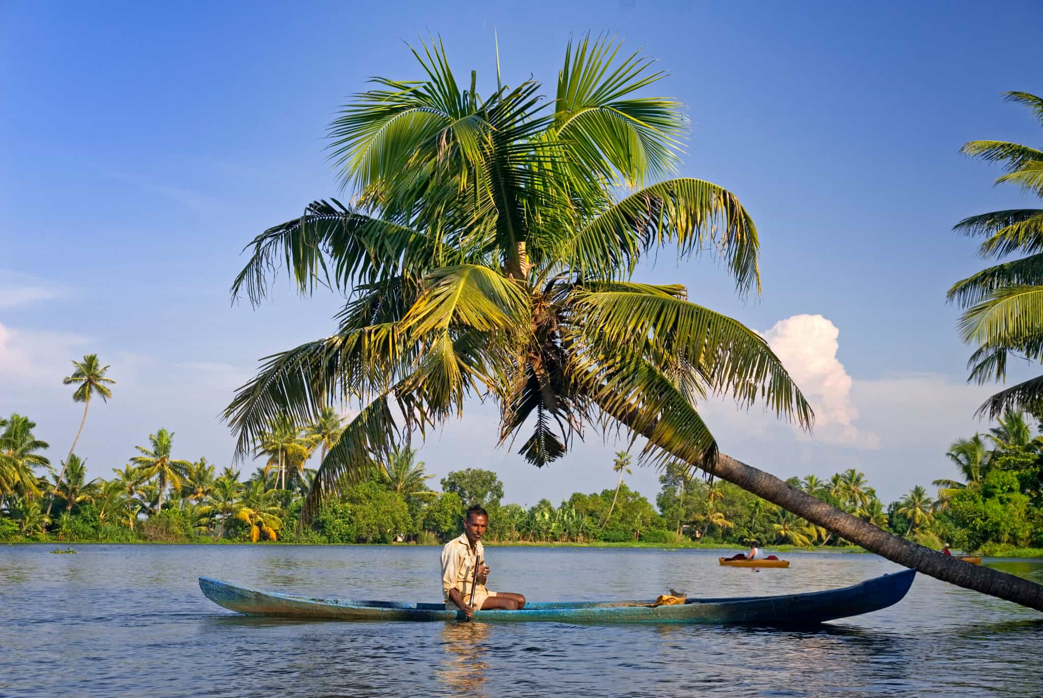 Local on a traditional canoe in the Keralan Backwaters, India