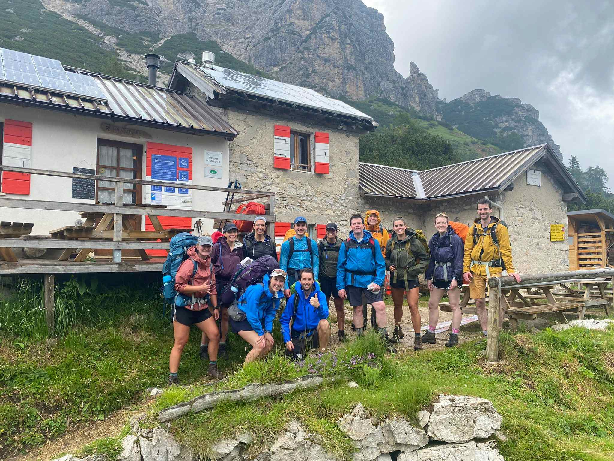Group standing in front of a hut, Dolomites, Italy. Photo: Customer/Annie Chamberlain