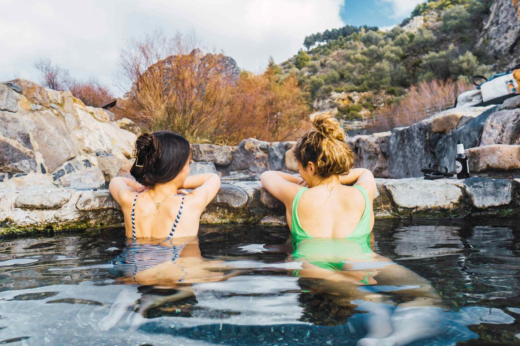 Two people relaxing in natural hot springs in Arnedillo, La Rioja, Spain
