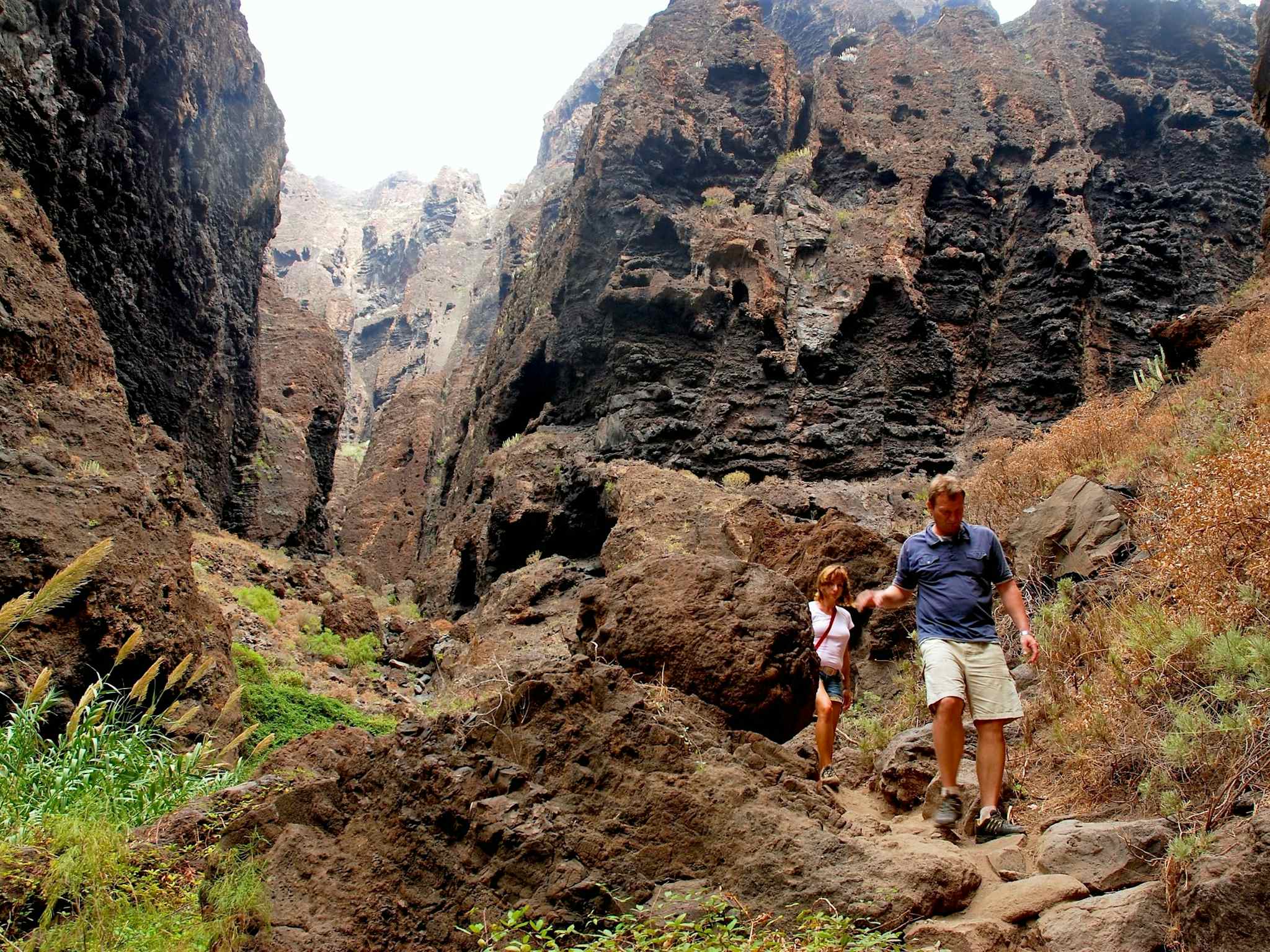Two people hiking through a canyon