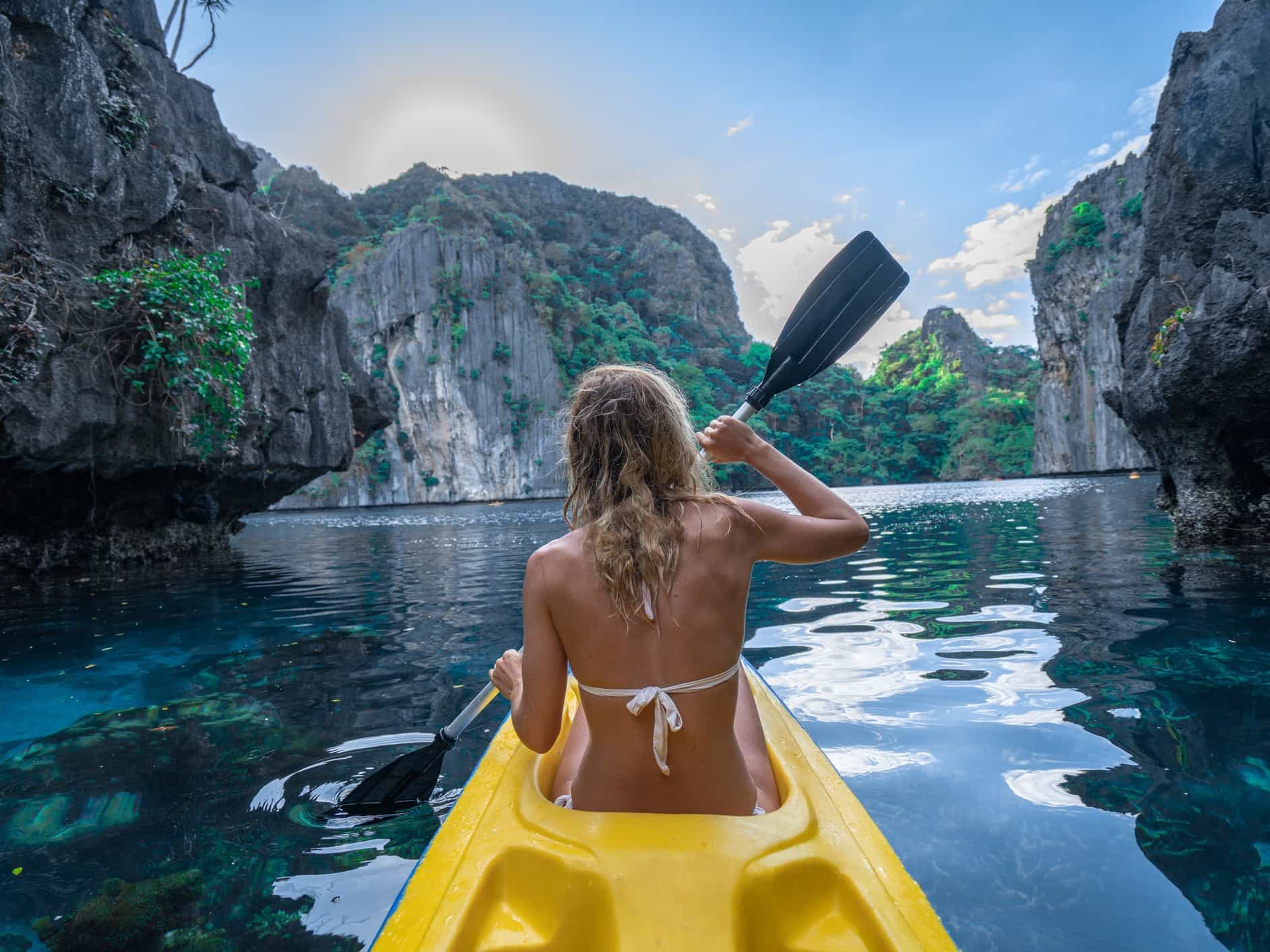 Woman canoeing in beautiful tropical lagoon