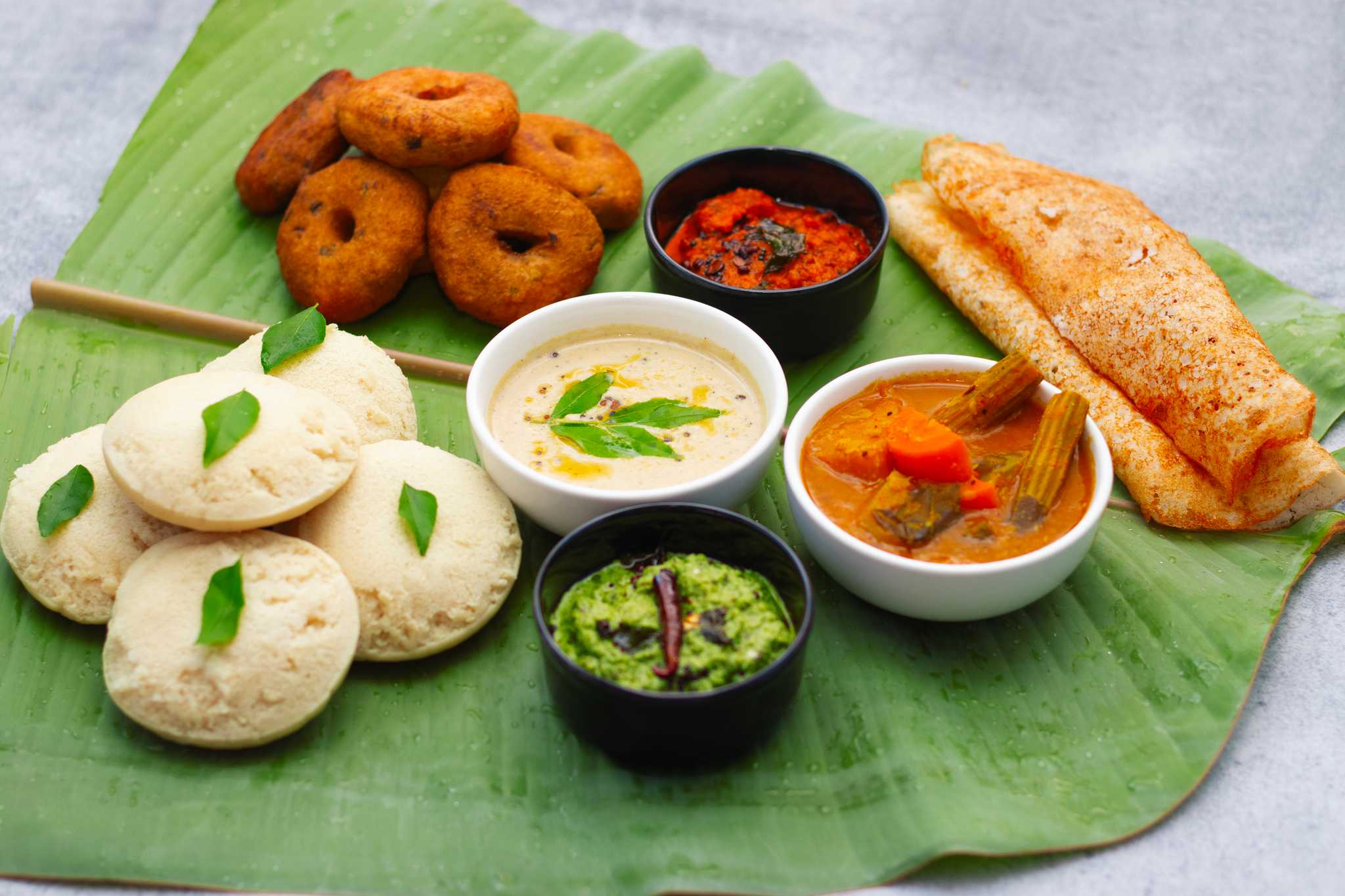 Famous South Indian food Idli Vada, Medu Vada, dosa with Sambar, coconut chutney and tomato chutney.
