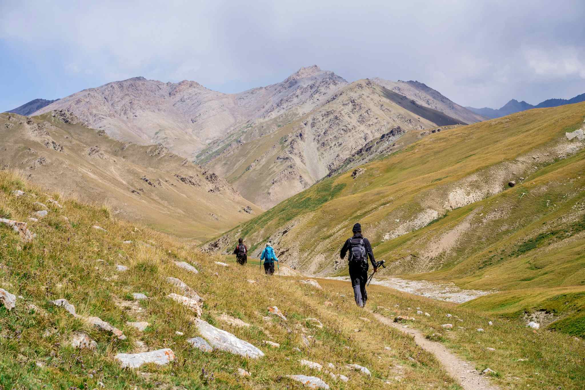 Hikers on a trail in Tash Rabat, Kyrgyzstan