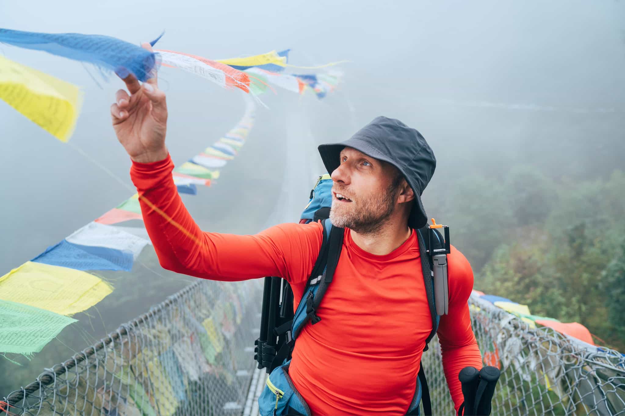 Trekker crosses a suspension bridge in Nepal