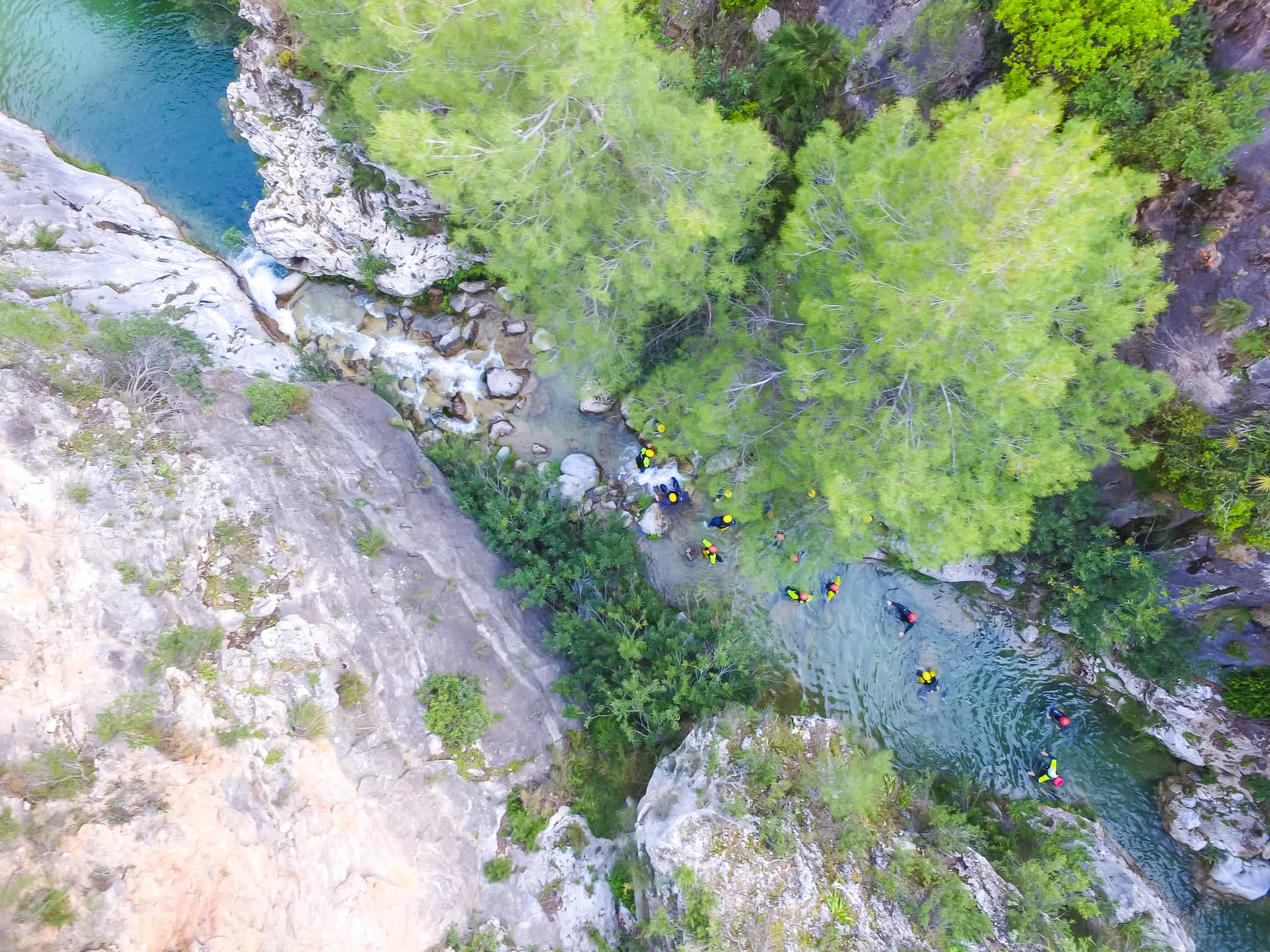 Group of people canyoning as seen from above in the Garganta del Verde, Andalucia.