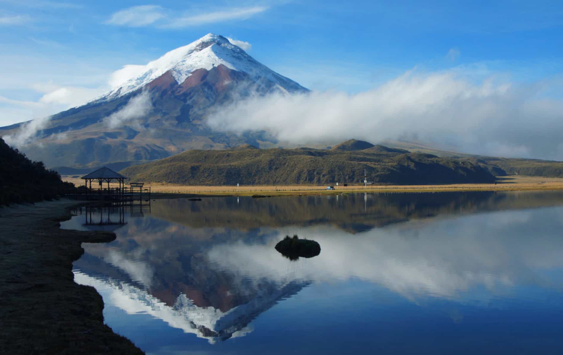 View of the Limpiopungo lagoon with the Cotopaxi volcano reflected in the water on a cloudy morning - Ecuador
