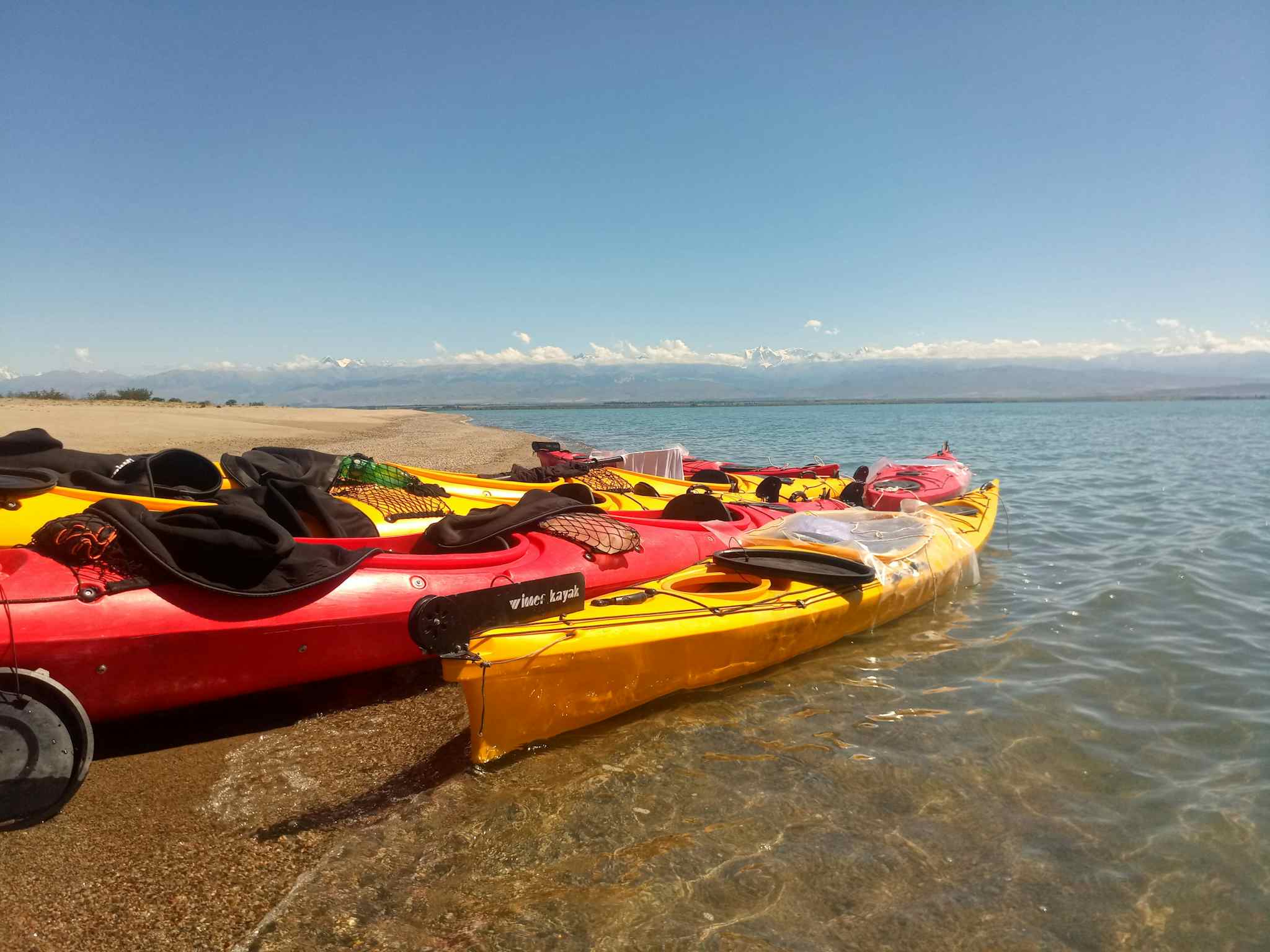 Kayaks on the shore of Song Kul Lake in Kyrgyzstan