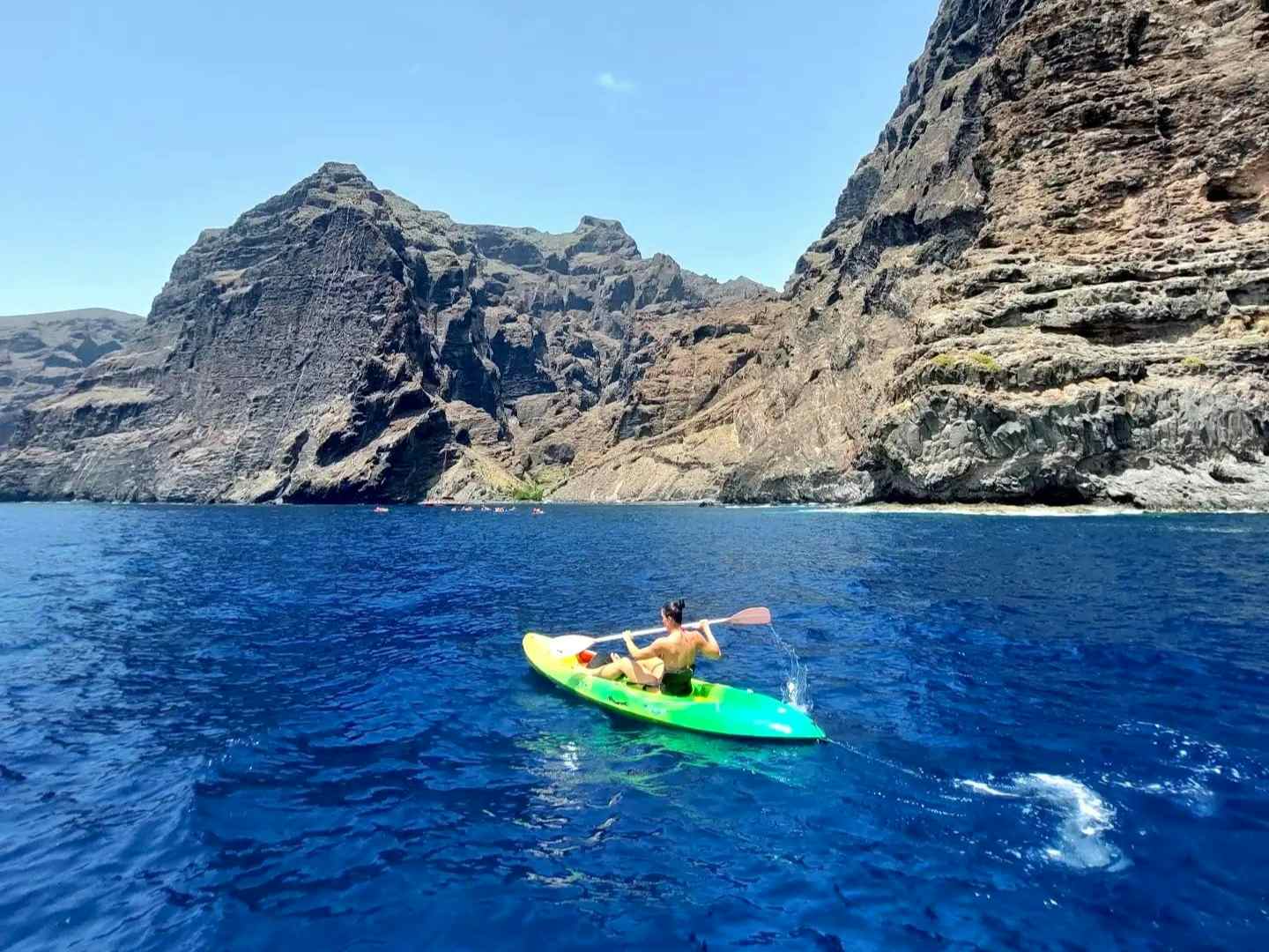 Girl kayaking at the cliffs of Los Gigantes in Tenerife