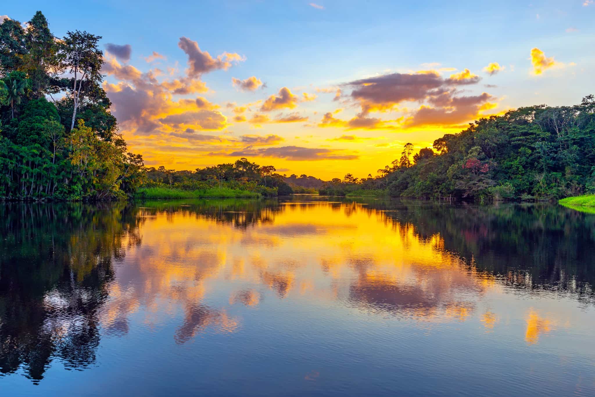 Sunset viewed across a river in the Amazon, Ecuador