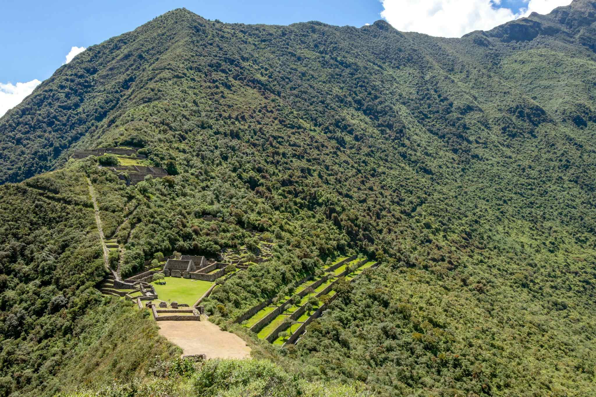 Choquequirao ruins on a mountaintop clearing above the Apurimac Jungle. Photo: Canva link: https://www.canva.com/photos/MADm3f1Hlwg-choquequirao-ancient-archaeological-complex-that-towers-above-the-apurimac-river-canyon-and-rests-atop-a-flattened-hill/