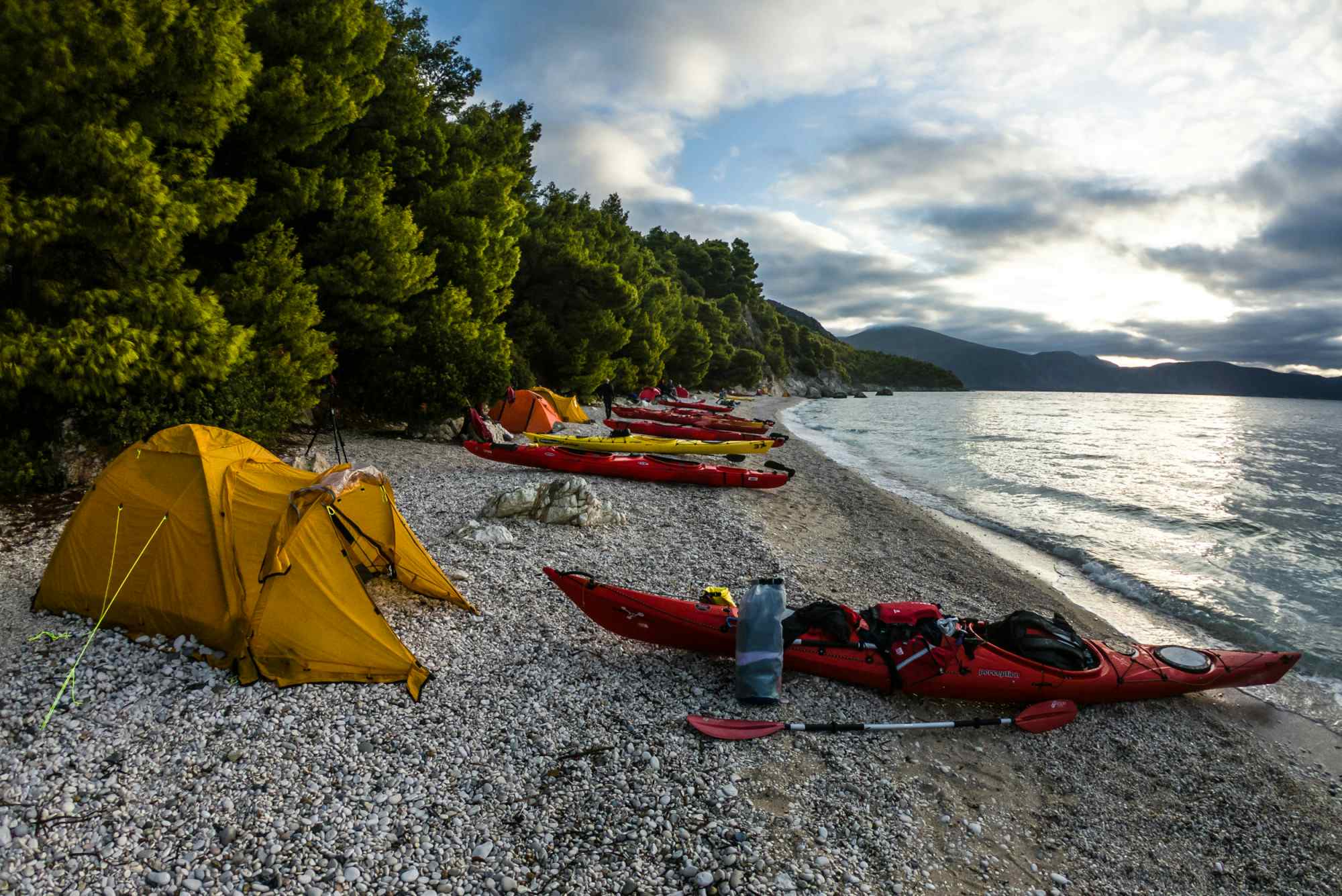 Wild beach camp with kayaks in the Ionian islands, Greece.