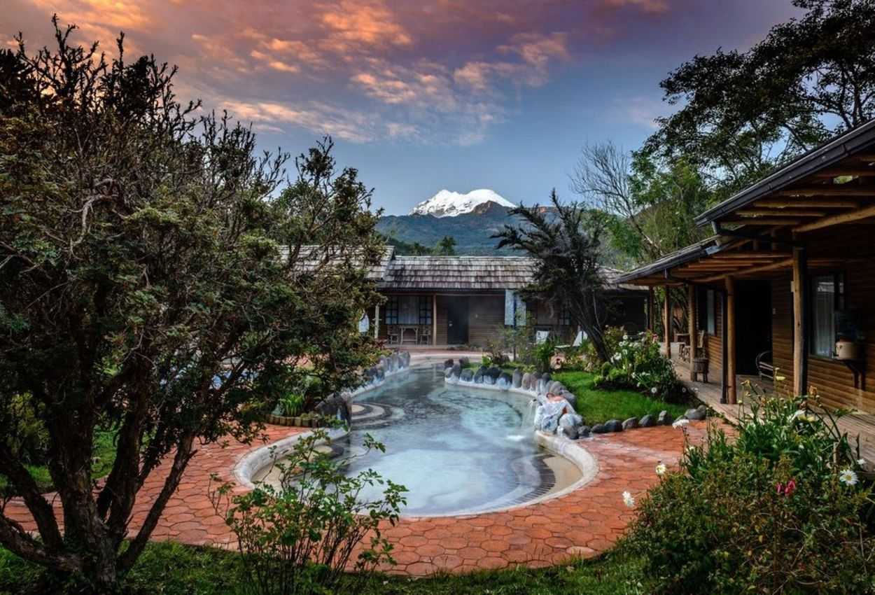 Pool with snowcapped mountain behind at the Termas de Papallacta hotel in Ecuador.