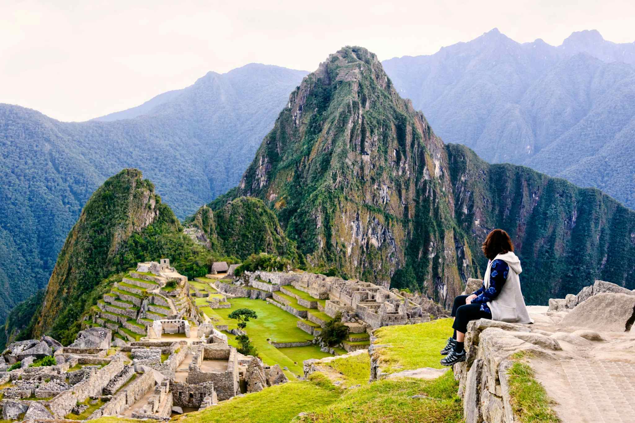 Women sitting overlooking Machu PIcchu, Peru