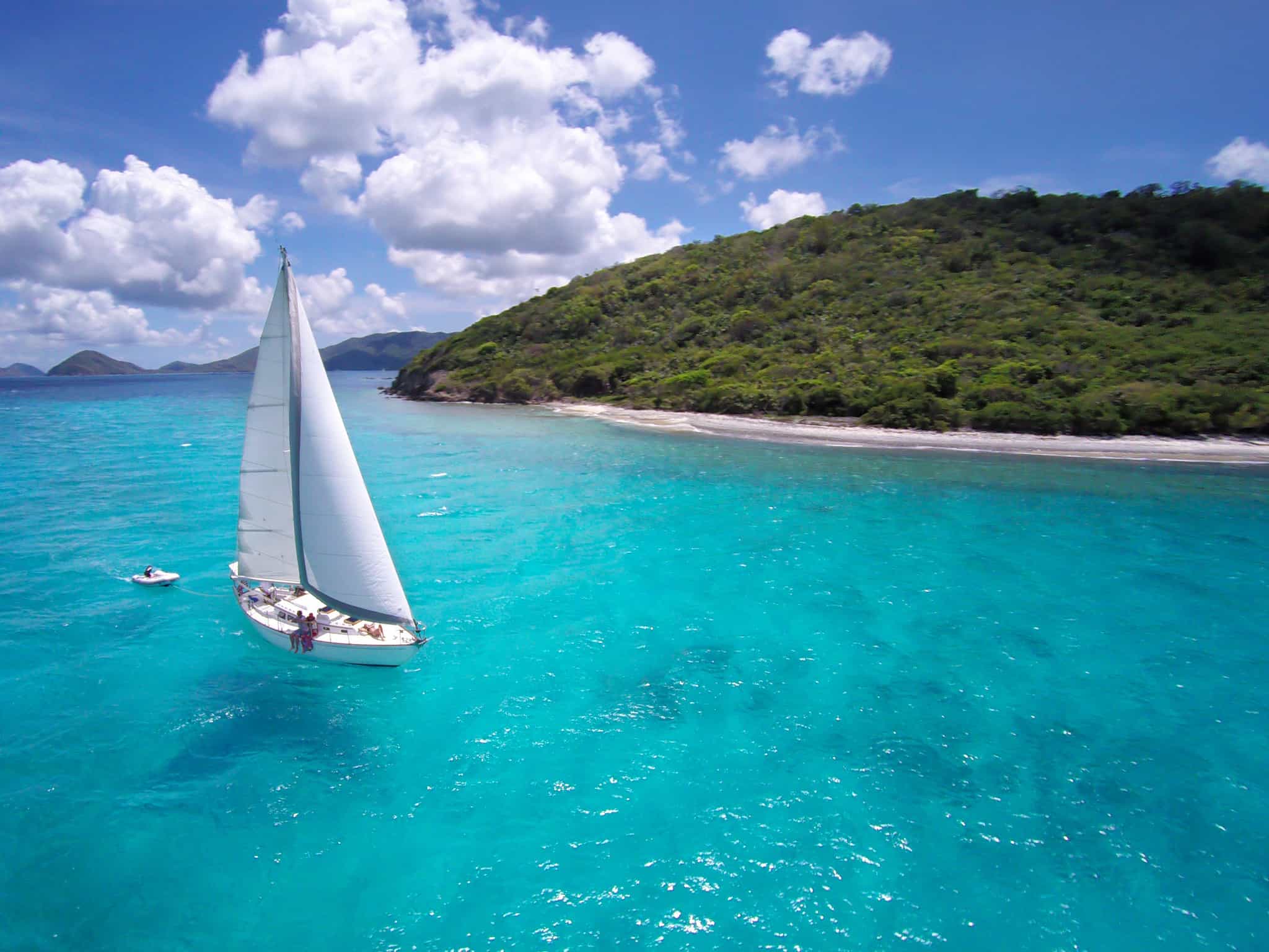 Sailing Boat on azure blue waters.