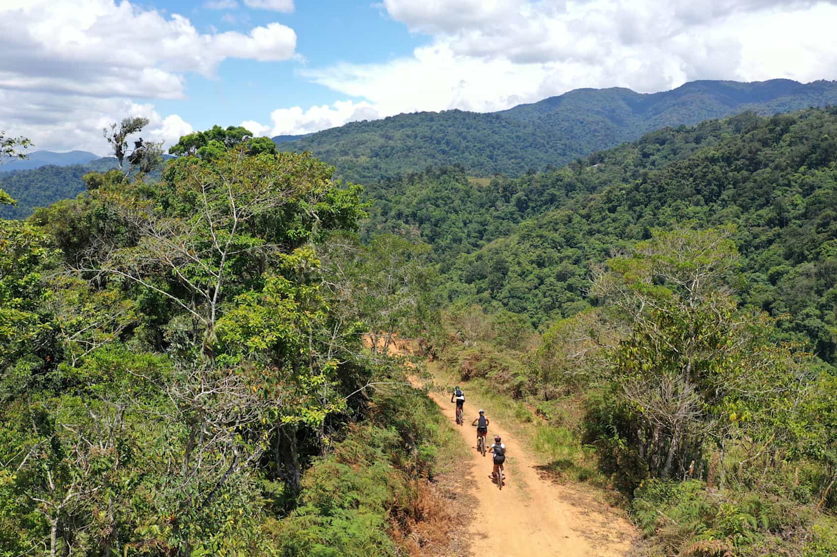 Three cyclists on a dirt road in Costa Rica