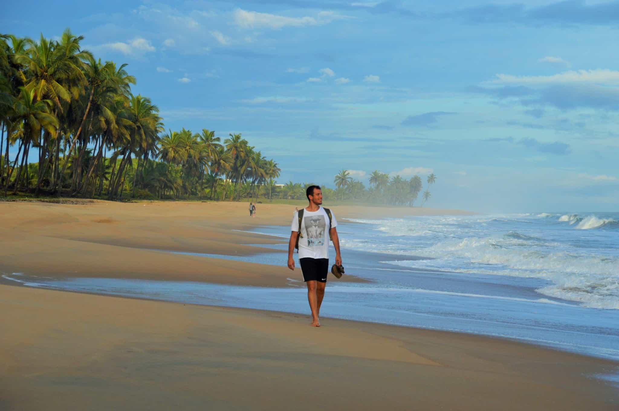 Man walking along the beaches of Cape Coast in Ghana.