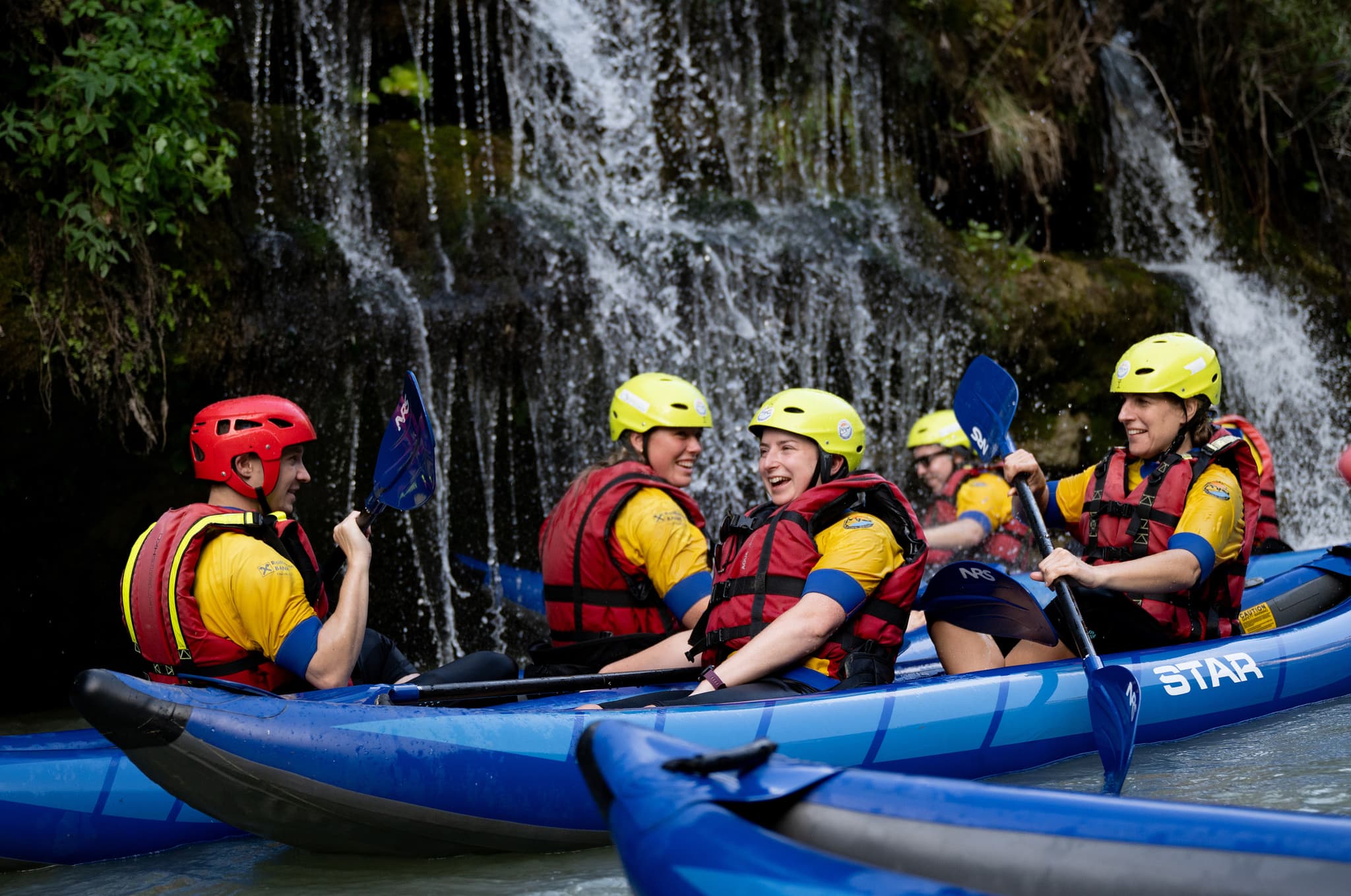 Kayakers passing by waterfalls on the Vjosa River in Albania.