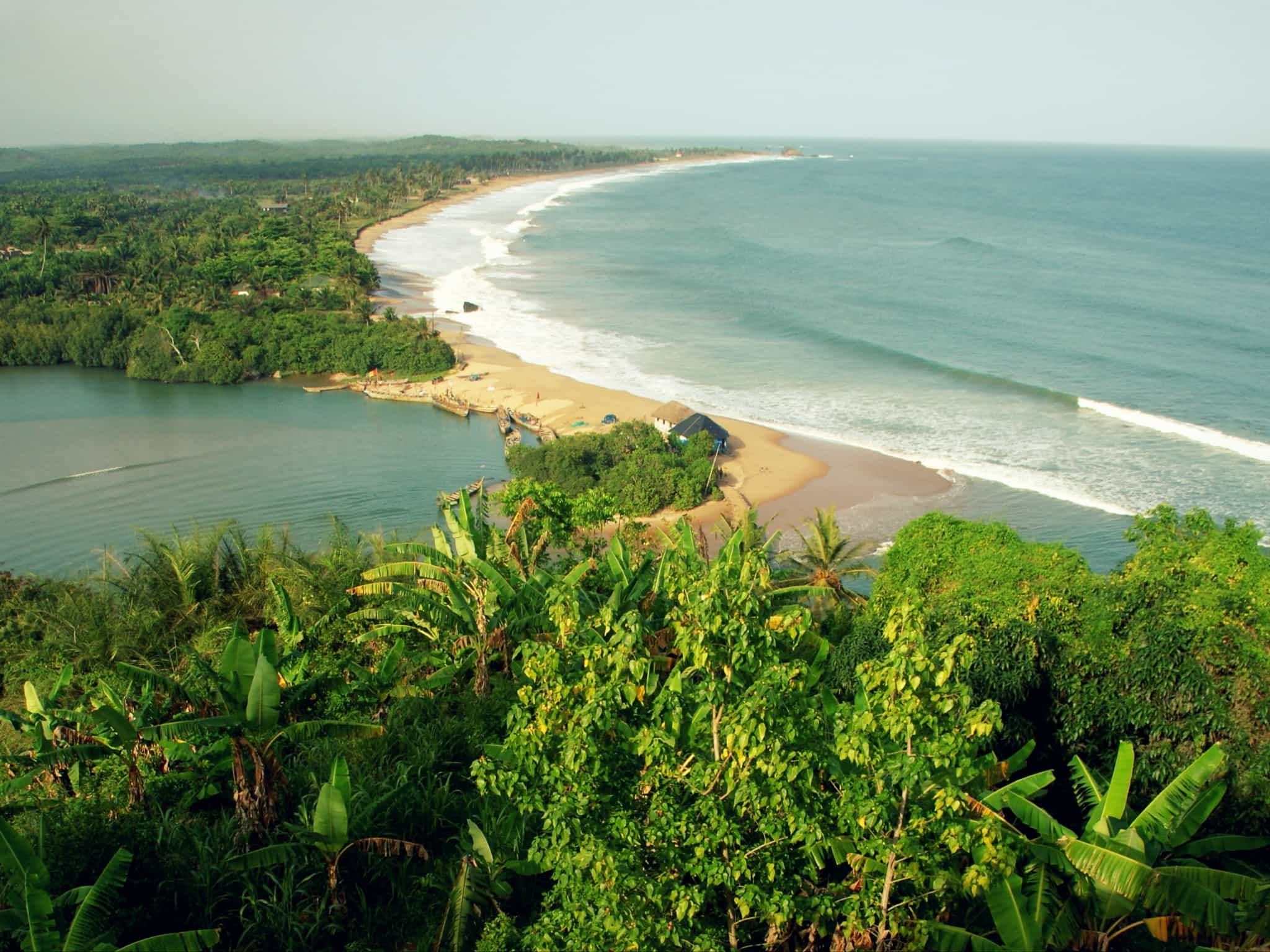 Aerial view of the forested shore on the wild Golden Coast of Ghana