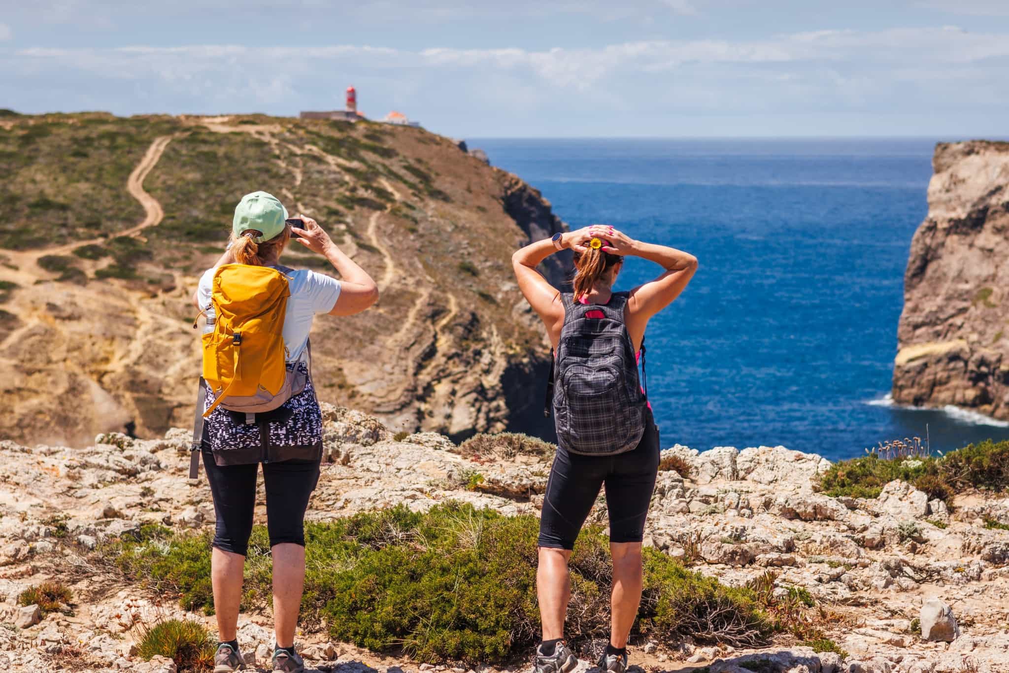 Hikers approaching Cabo de São Vicente, Sagres, Portugal