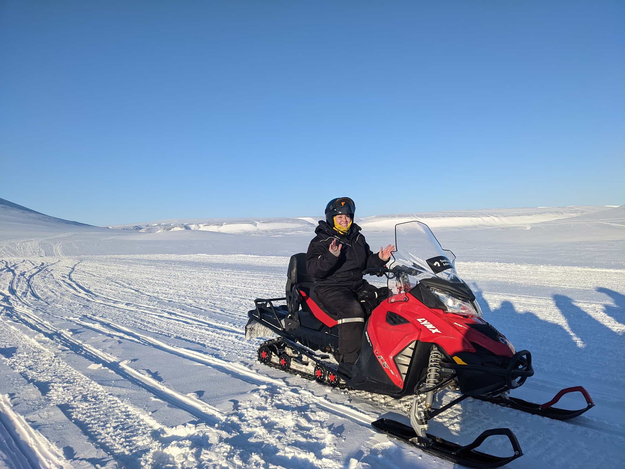 Person on a snowmobile in Svalbard.