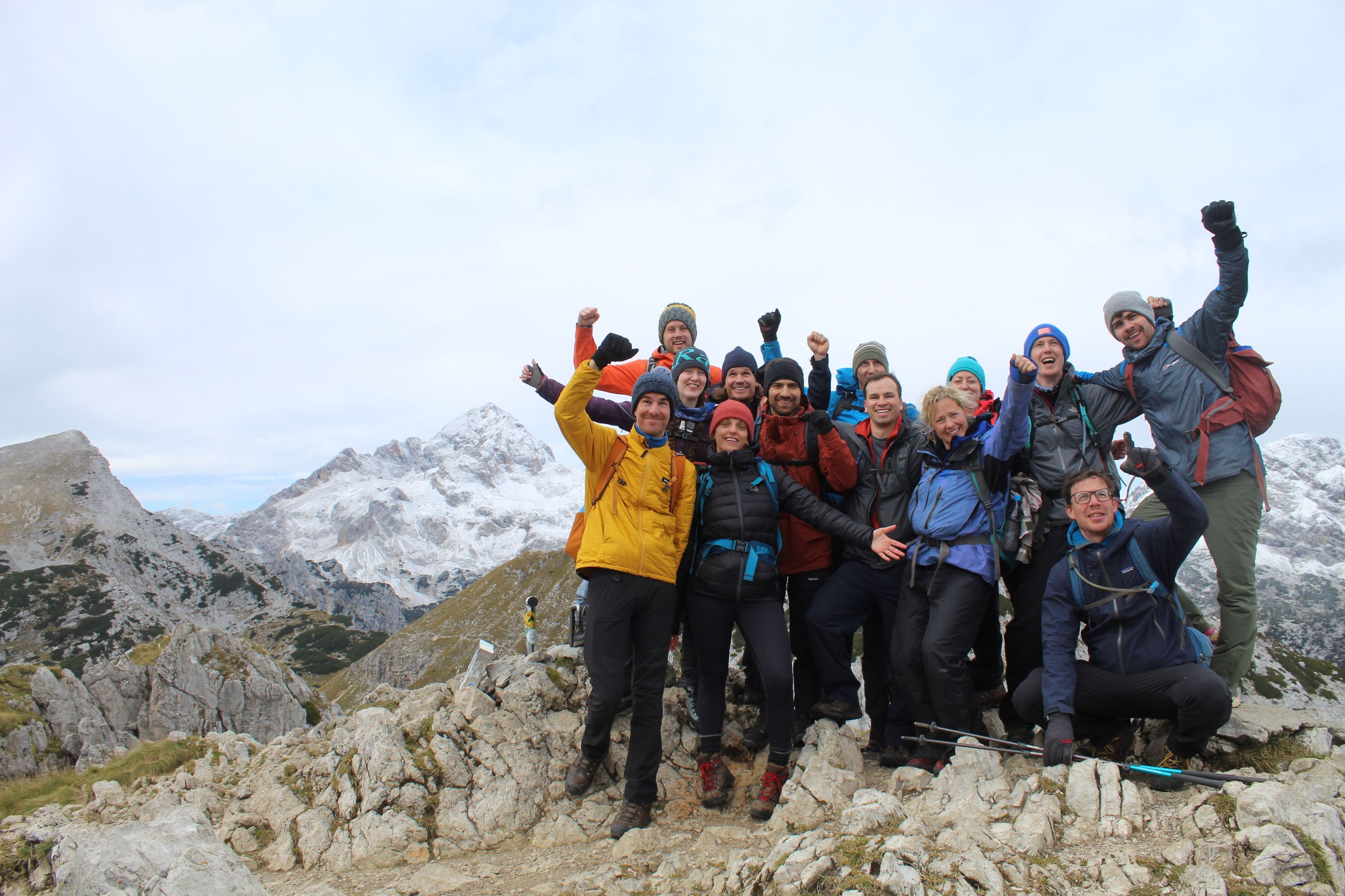 The Much Better Adventures staff team pose at the top of Viševnik, a mountain in Slovenia.