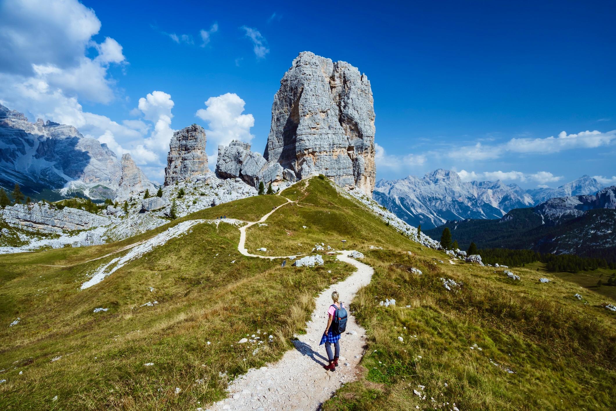 A hiker gazes at the Cinque Torri, in Italy's Dolomites National Park