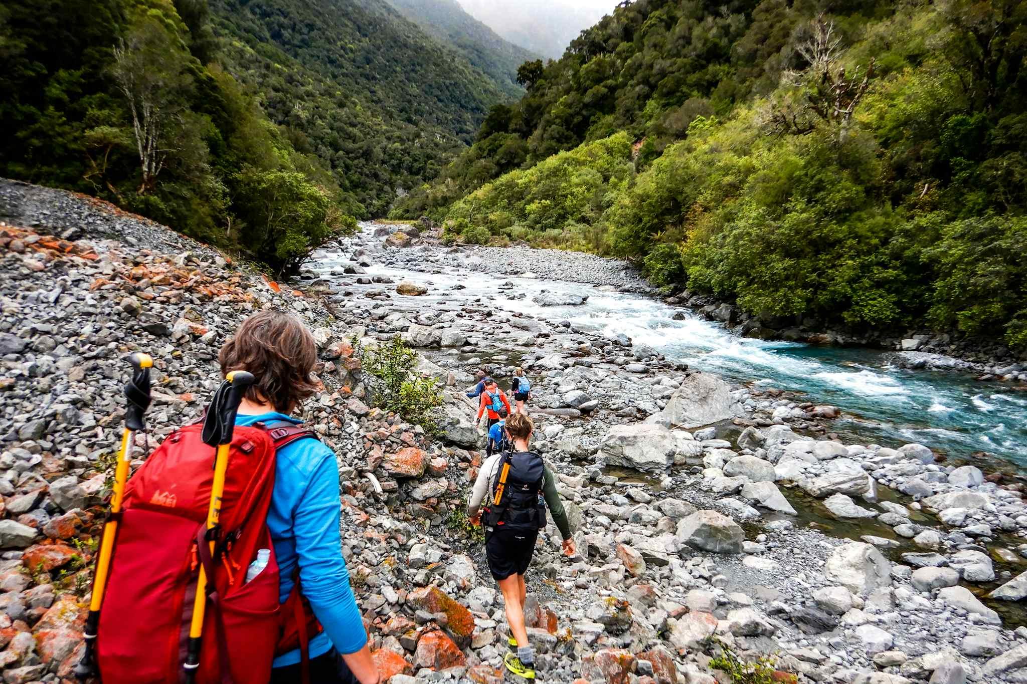 Hikers climb up towards Goat Pass, New Zealand