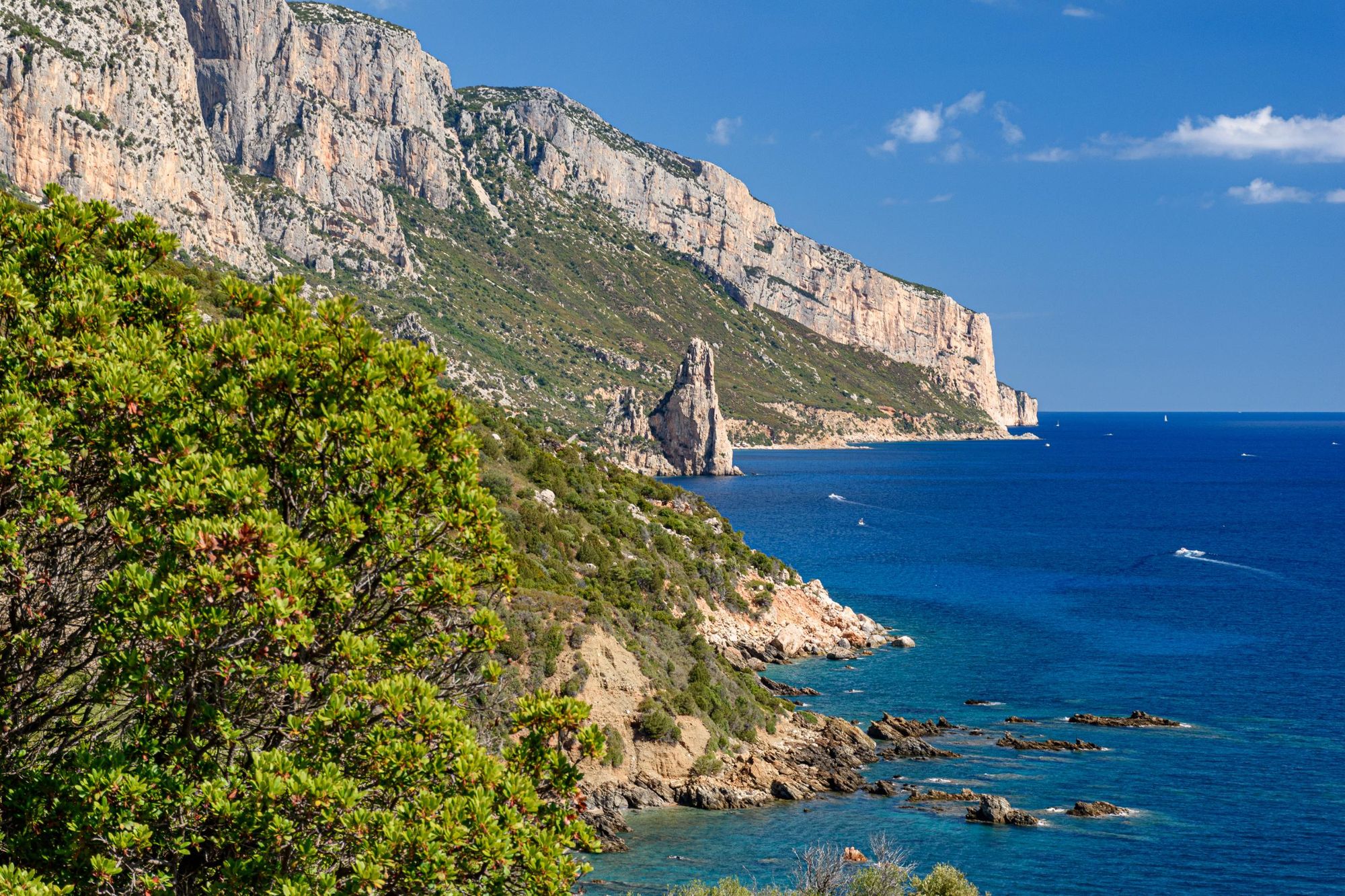 A coastline near Santa Maria Navarrese with the rock pinnacle Pedra Longa in the background in east Sardinia. Photo: Getty