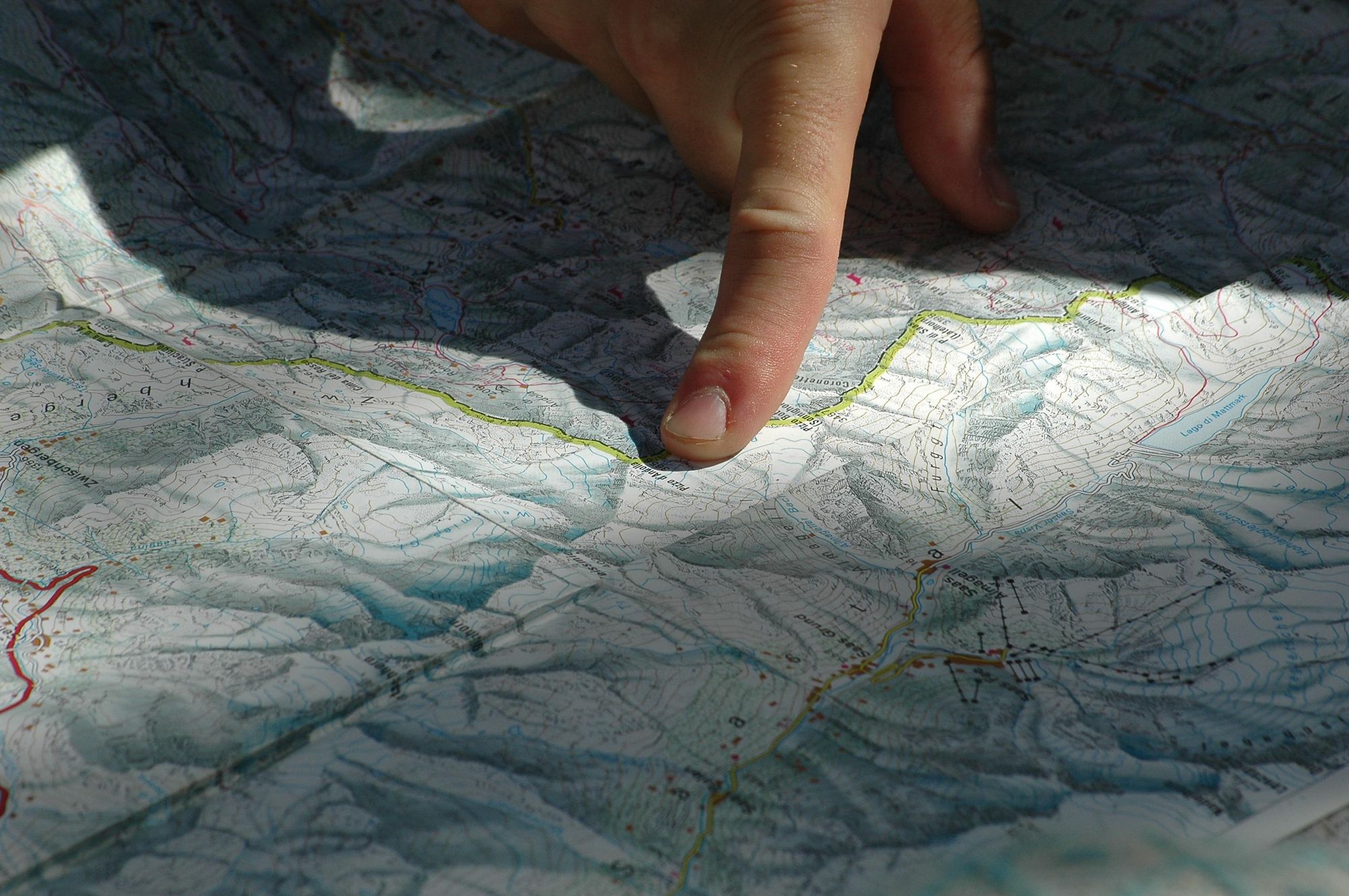 Over the map, plotting out a route through the mountains. Photo: Getty