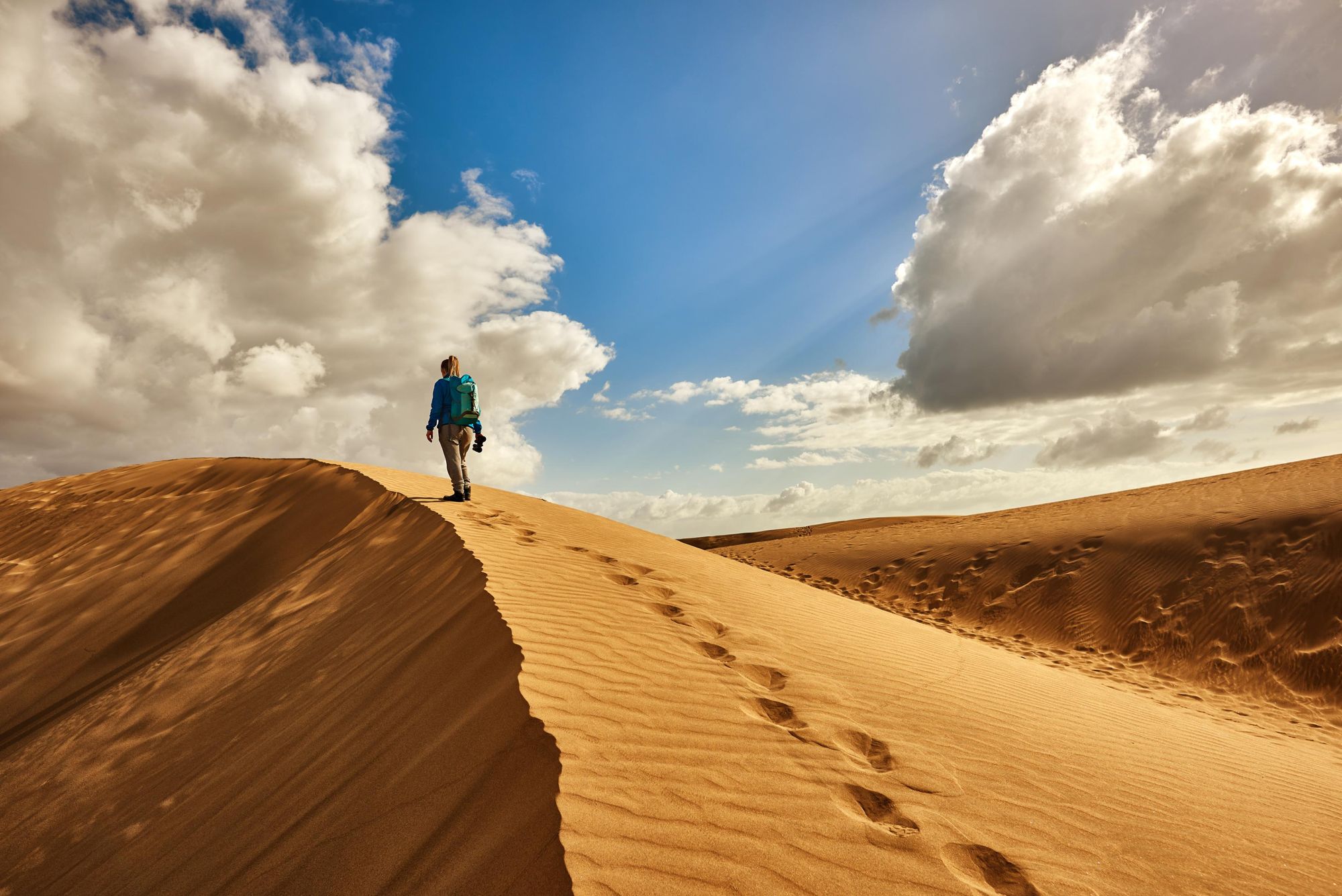 Hiking along a sand dune in Morocco. Photo: Getty