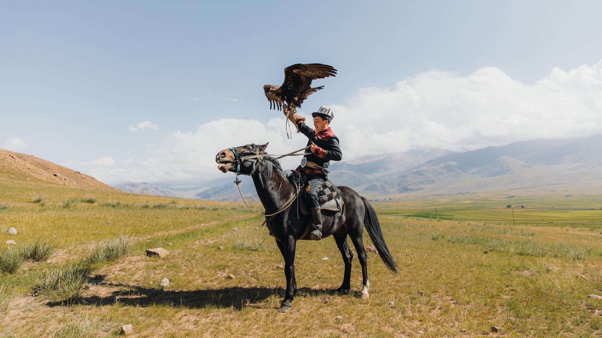 A portrait of a male hunter and his eagle in the wilderness area of Tian Shan mountains, Kyrgyzstan. Photo: Getty