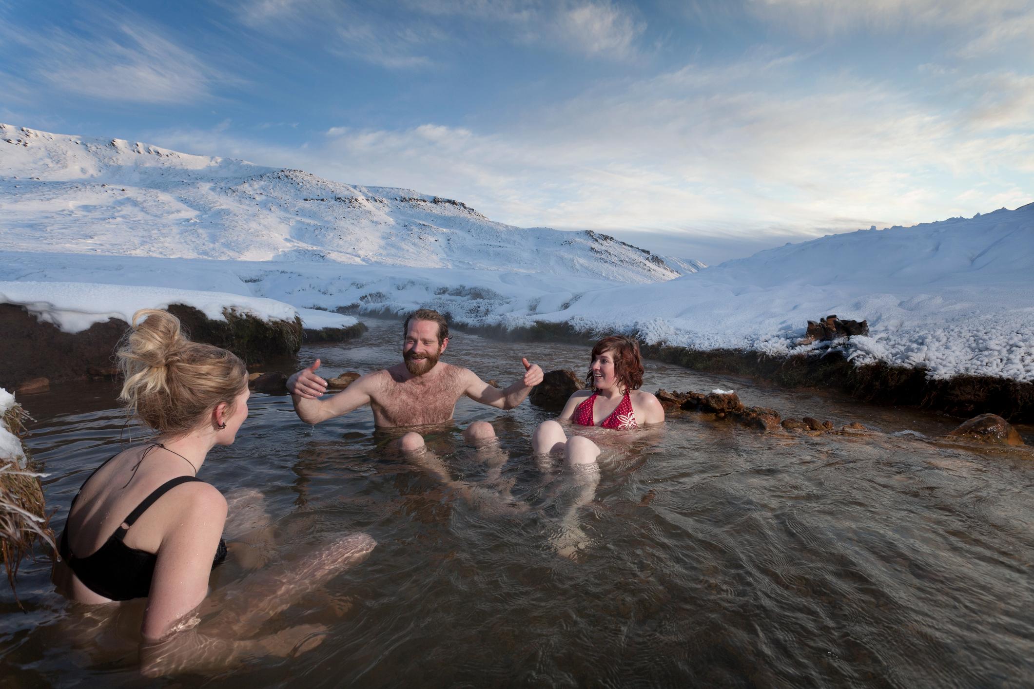 Socialising in one of Iceland's many natural hot pools. Photo: Getty.