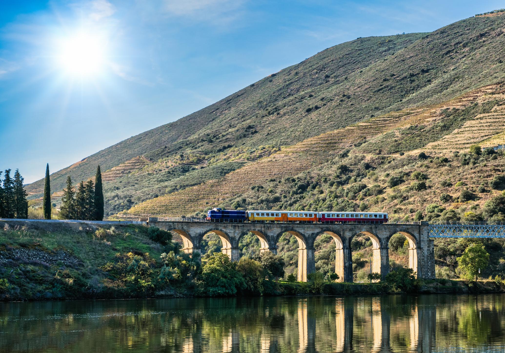 A train passing over the bridge in the Douro Vineyard Valley, Pocinho, Portugal. Photo: Getty